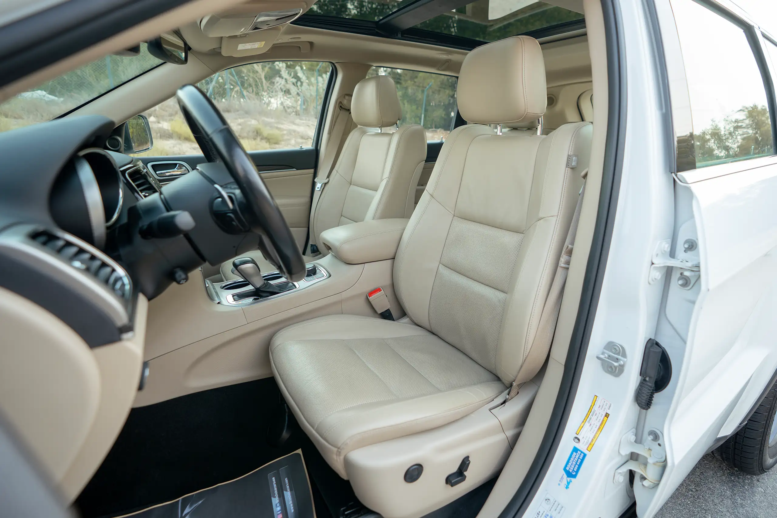 Used 2021 Jeep Grand Cherokee Limited White – Front Driver Side Cabin View at First Choice Cars Sharjah