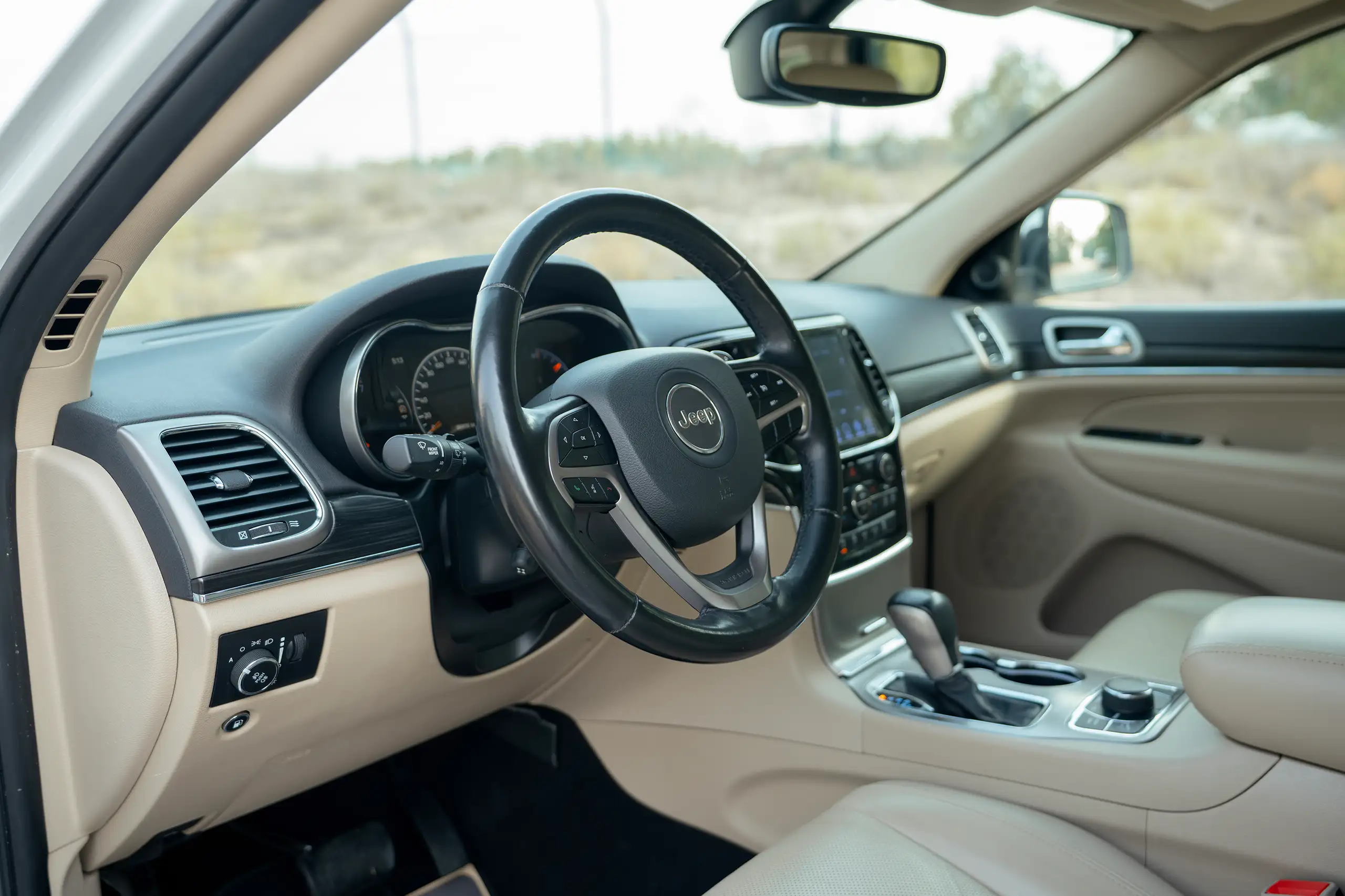 Used 2021 Jeep Grand Cherokee Limited White – Driver Side Dashboard & Steering View at First Choice Cars Sharjah