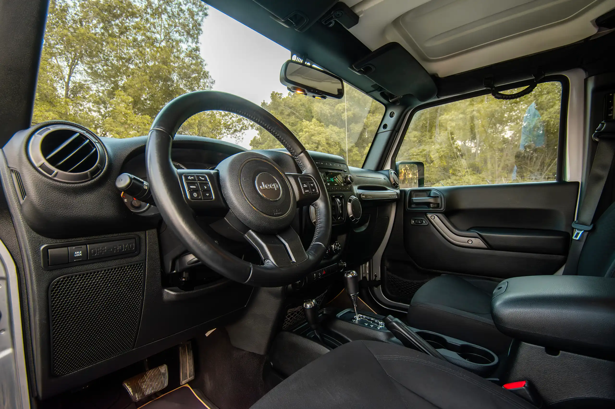 Used 2018 Jeep Wrangler Unlimited Willys Wheeler in Silver – Driver Side Dashboard & Steering View for Sale at First Choice Cars Dubai Sharjah