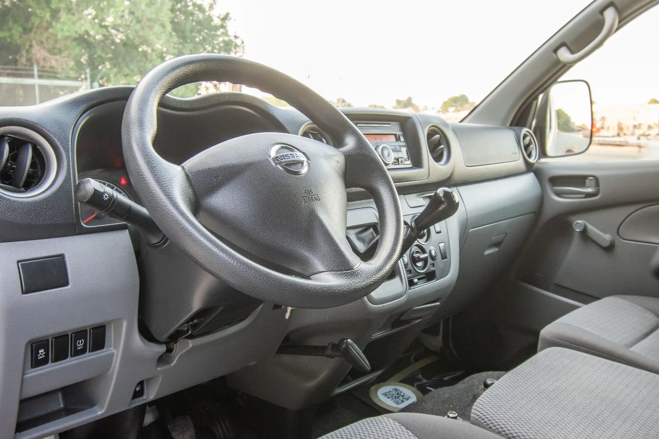 Used 2016 Nissan Urvan Standard Roof White – Driver Side Dashboard & Steering View at First Choice Cars Sharjah