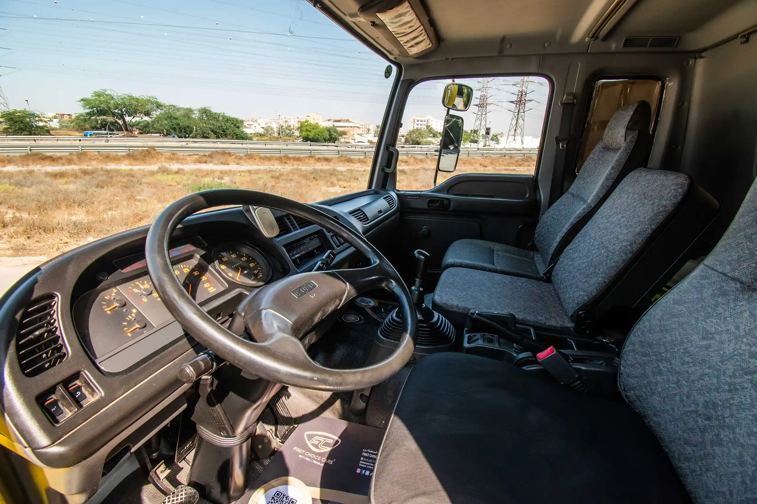 Used 2016 Isuzu FSR Cargo Body in Yellow – Driver Side Dashboard & Steering View for Sale at First Choice Cars Dubai Sharjah