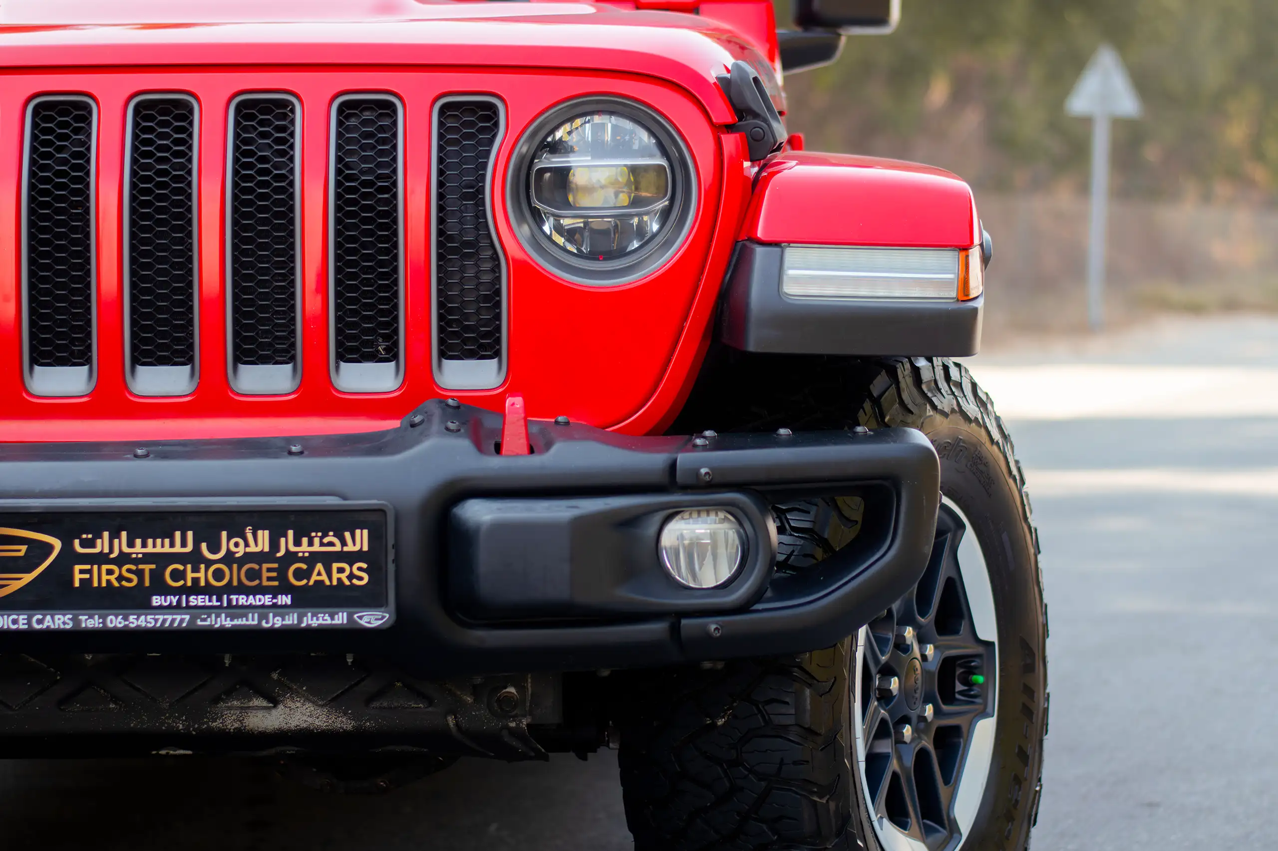 Used 2020 Jeep Wrangler Rubicon Red – Headlight Close-up at First Choice Cars Sharjah