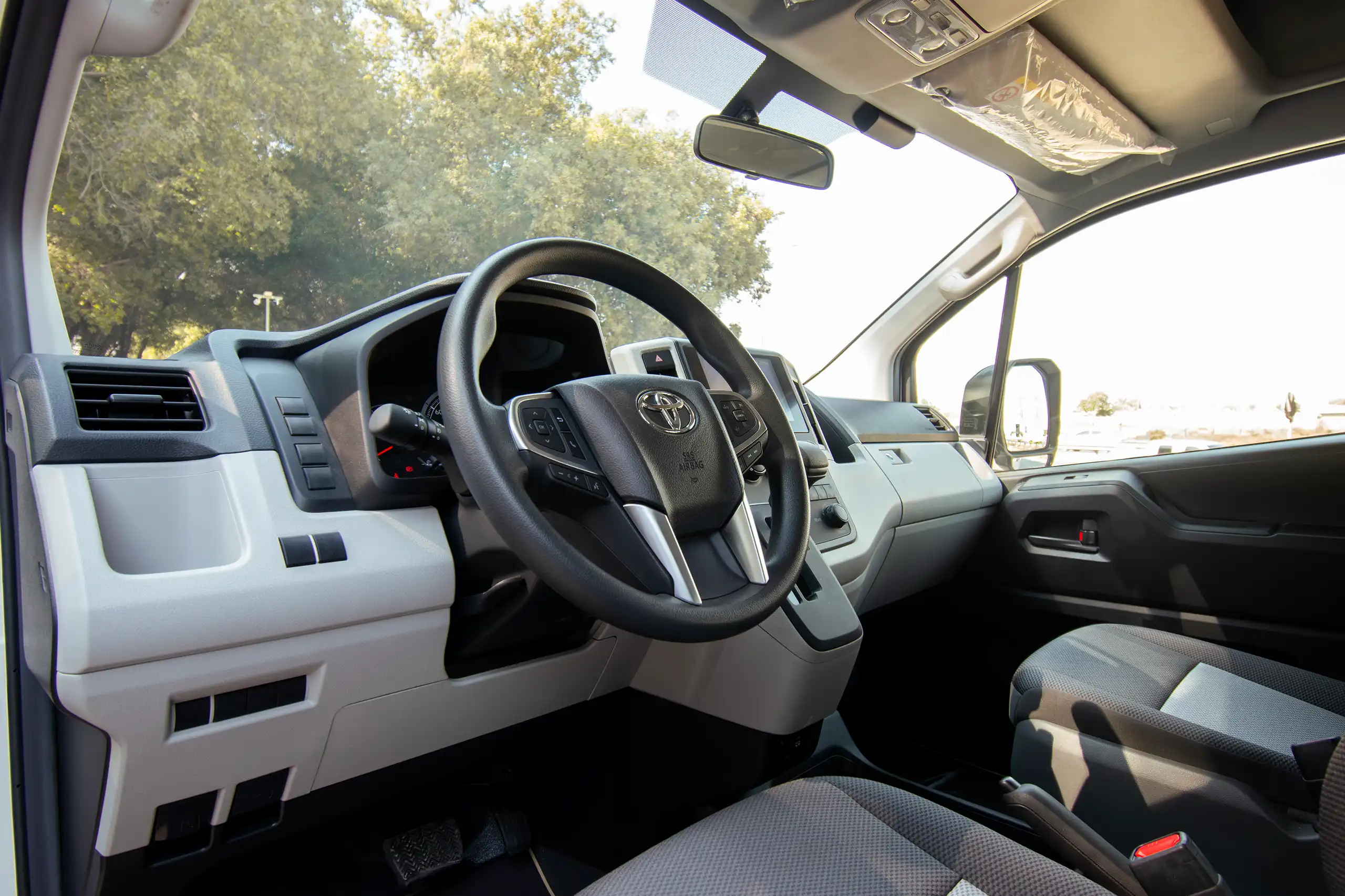 Used 2025 Toyota Hiace GL High Roof White – Driver Side Dashboard & Steering View at First Choice Cars Sharjah