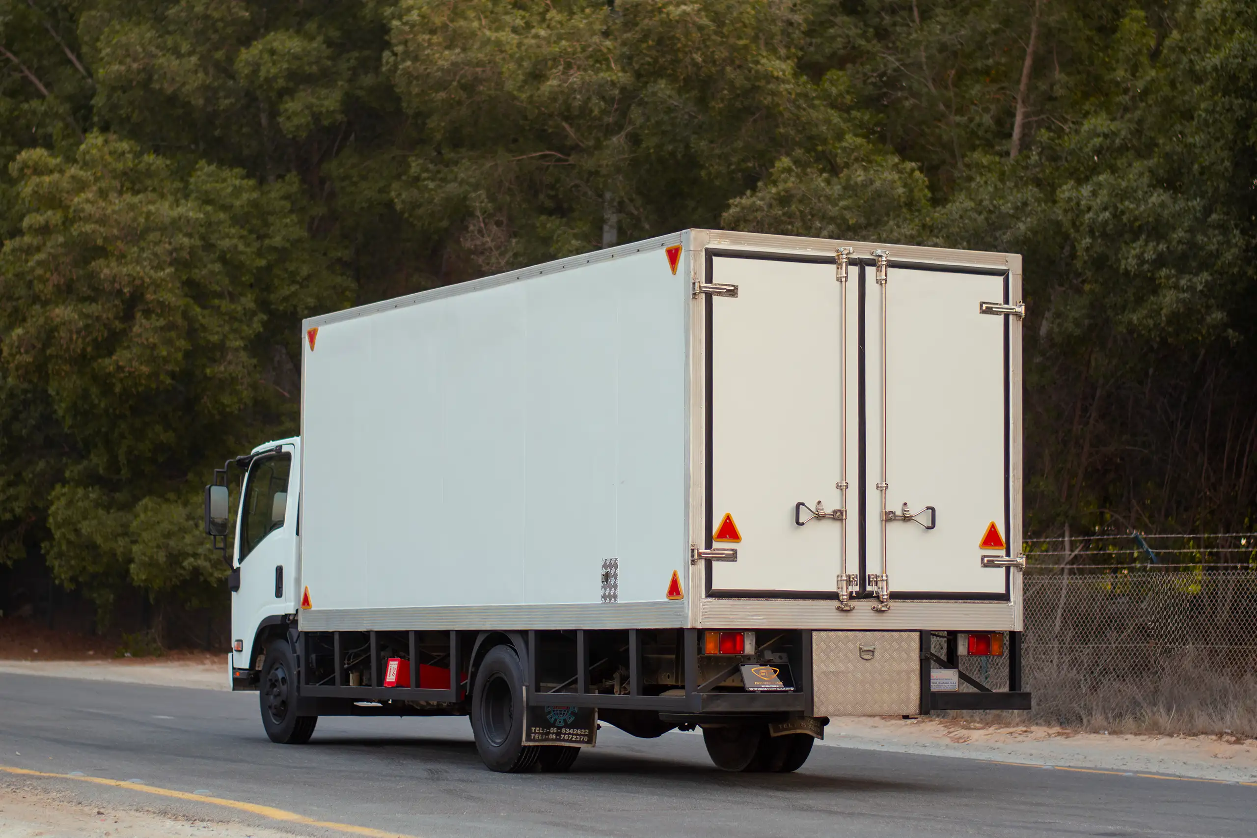 Used 2016 Isuzu NPR Freezer Box White – Left Back Diagonal (45°) View at First Choice Cars Sharjah