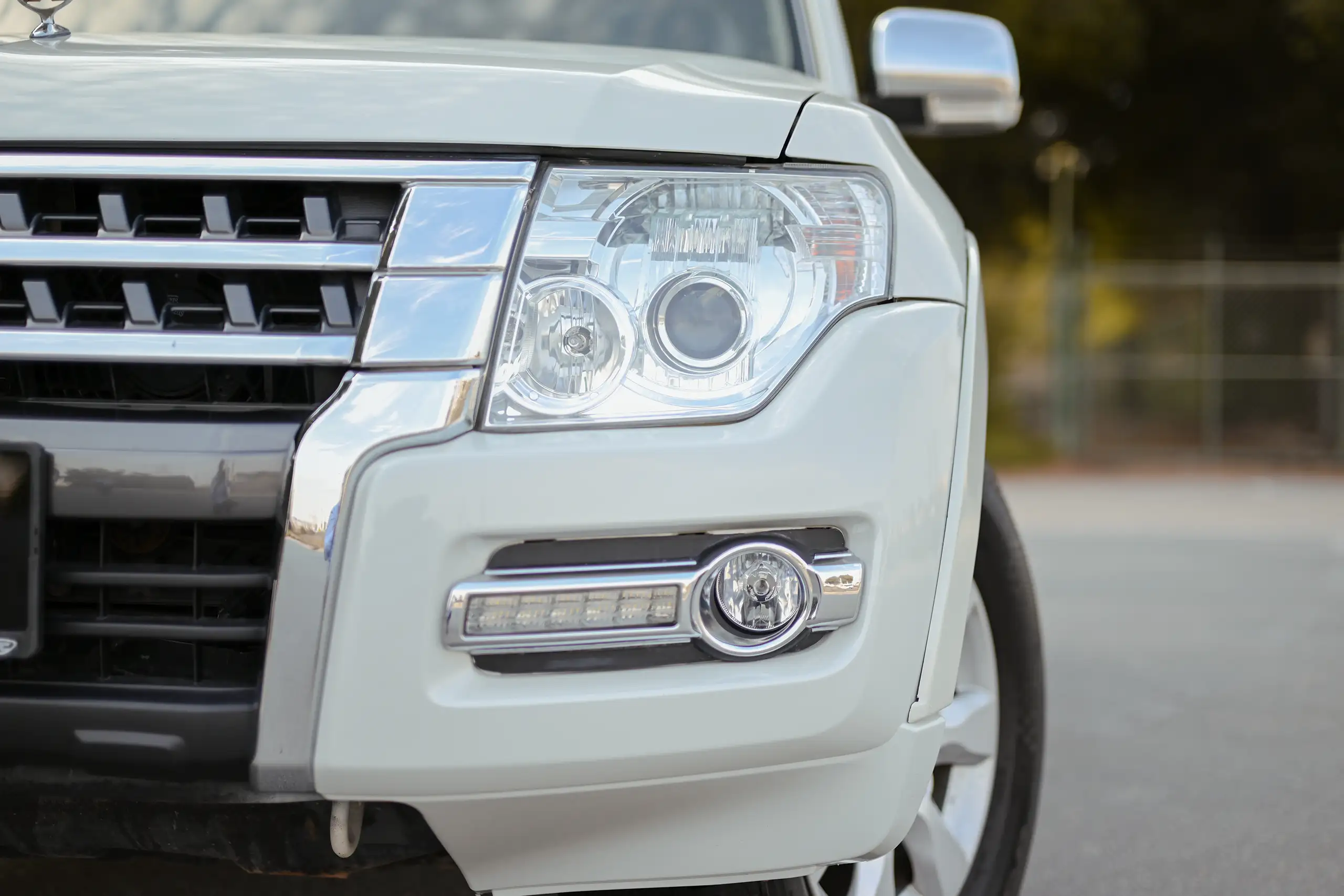 Used 2022 Mitsubishi PAJERO GLS White – Headlight Close-up at First Choice Cars Sharjah