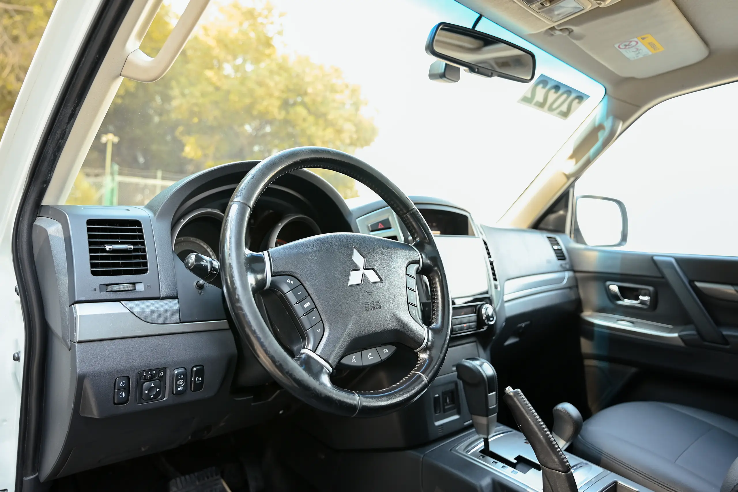 Used 2022 Mitsubishi PAJERO GLS White – Driver Side Dashboard & Steering View at First Choice Cars Sharjah