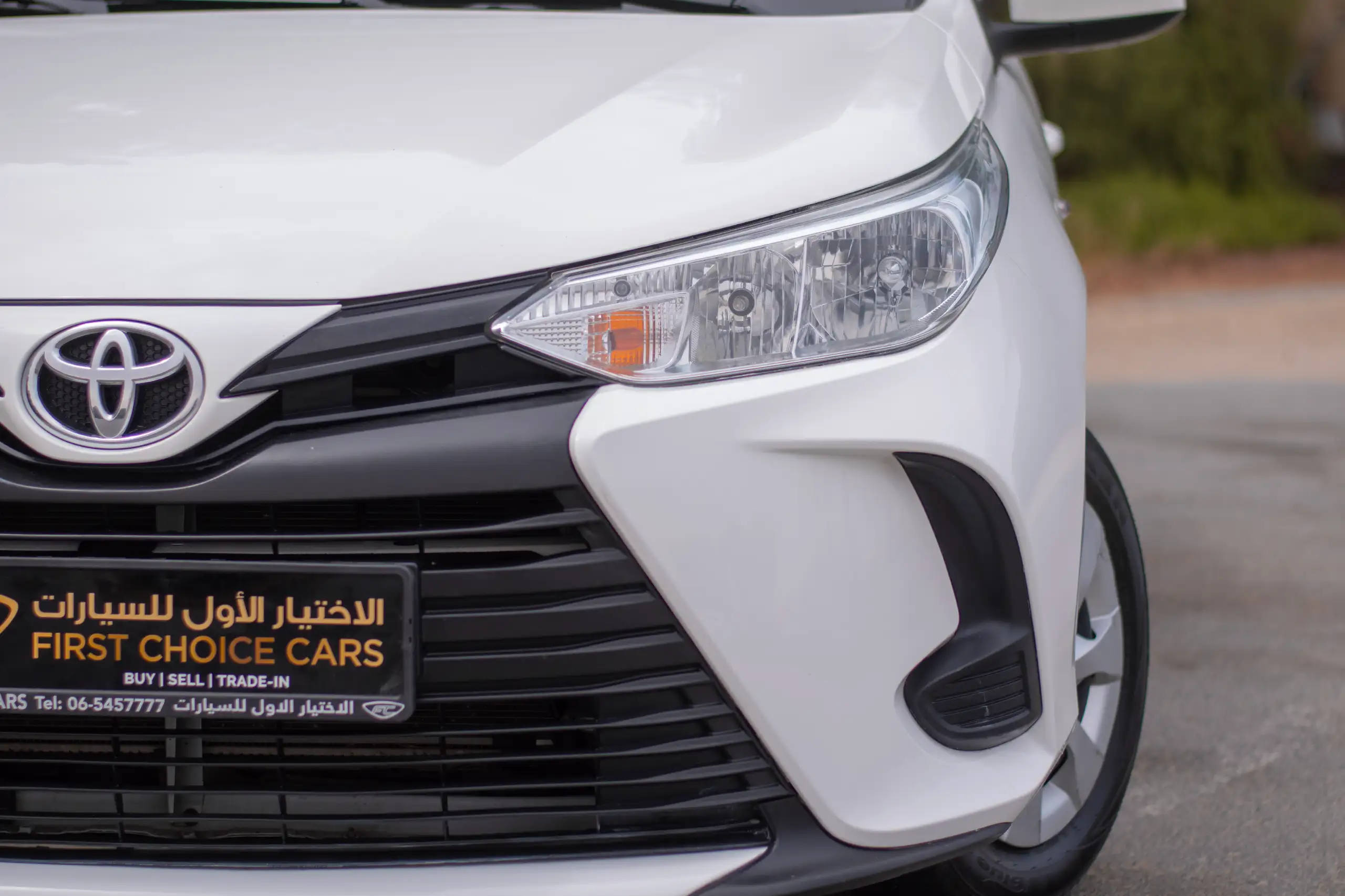Used 2022 Toyota Yaris E in White – Headlight Close-up for Sale at First Choice Cars Dubai Sharjah