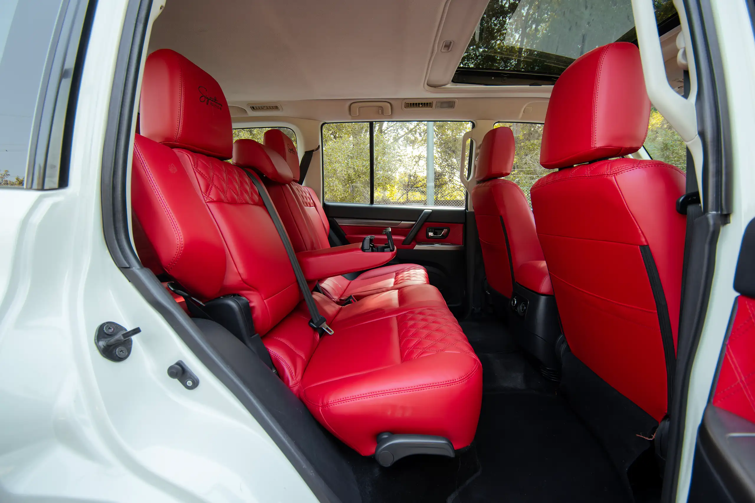 Used 2022 Mitsubishi Pajero GLS White – Rear Driver Side Cabin View at First Choice Cars Sharjah