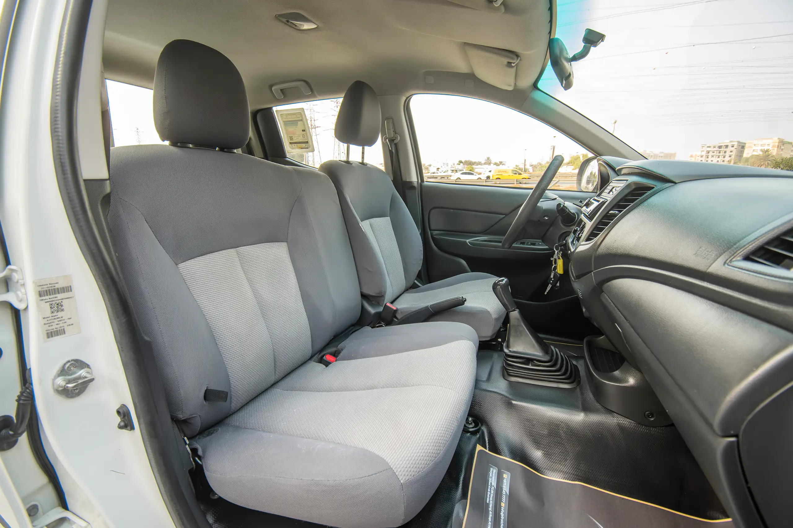 Used 2021 Mitsubishi L200 GL Double Cabin White – Front Passenger Side Cabin View at First Choice Cars Sharjah