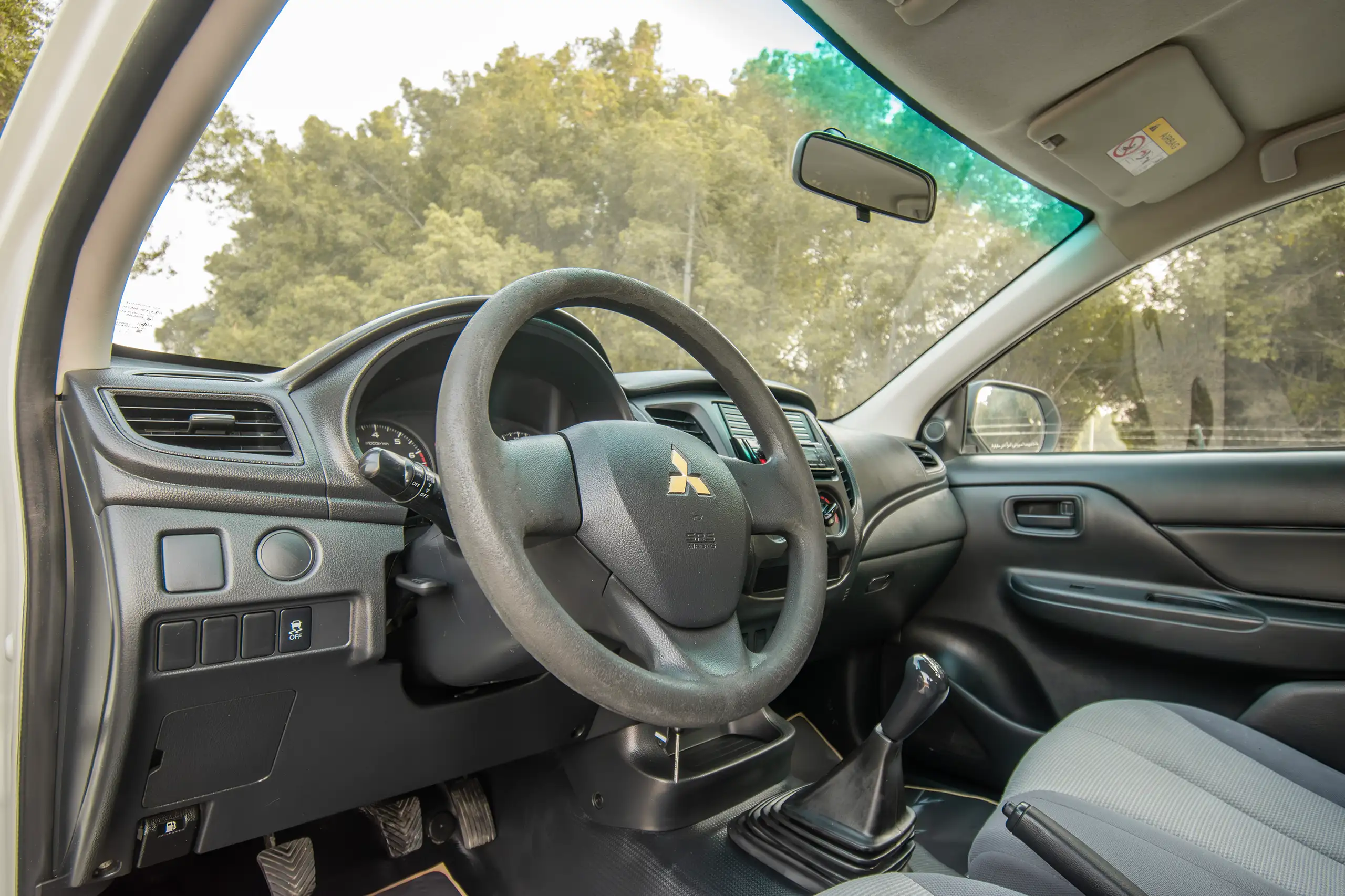 Used 2021 Mitsubishi L200 GL Double Cabin White – Driver Side Dashboard & Steering View at First Choice Cars Sharjah