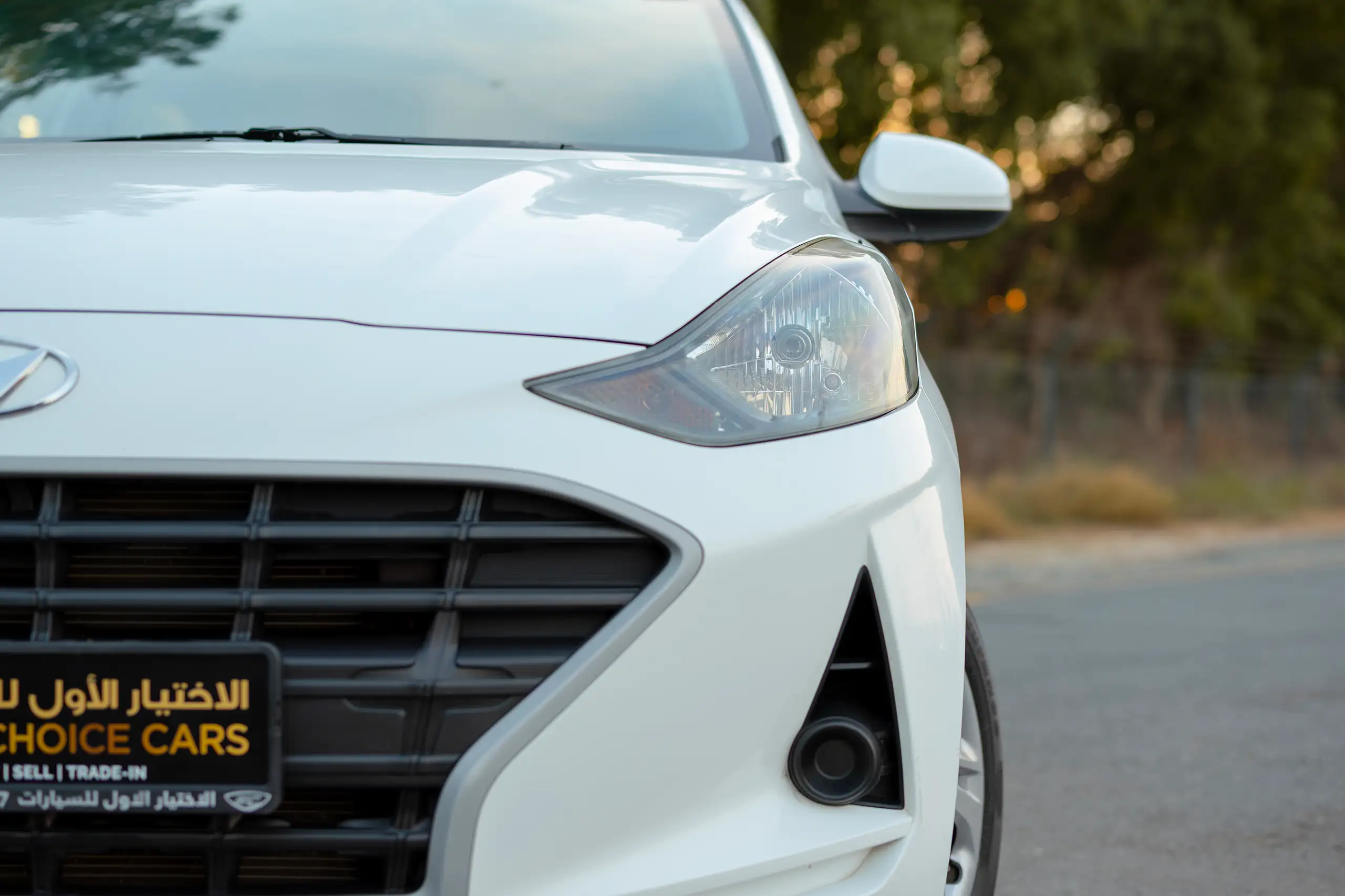 Used 2023 Hyundai Grand i10 Smart White – Headlight Close-up at First Choice Cars Sharjah