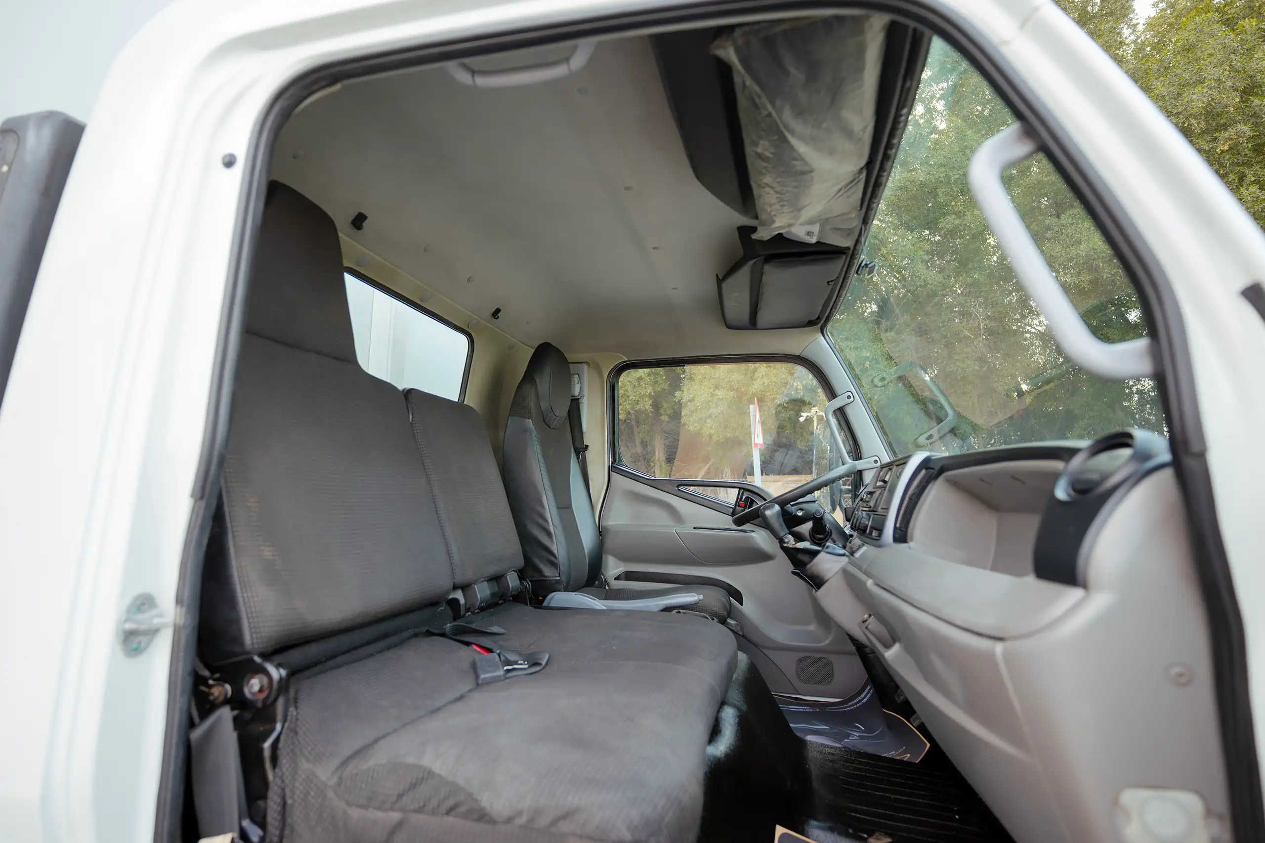 Used 2020 Mitsubishi Canter Chiller Box White – Front Passenger Side Cabin View at First Choice Cars Sharjah