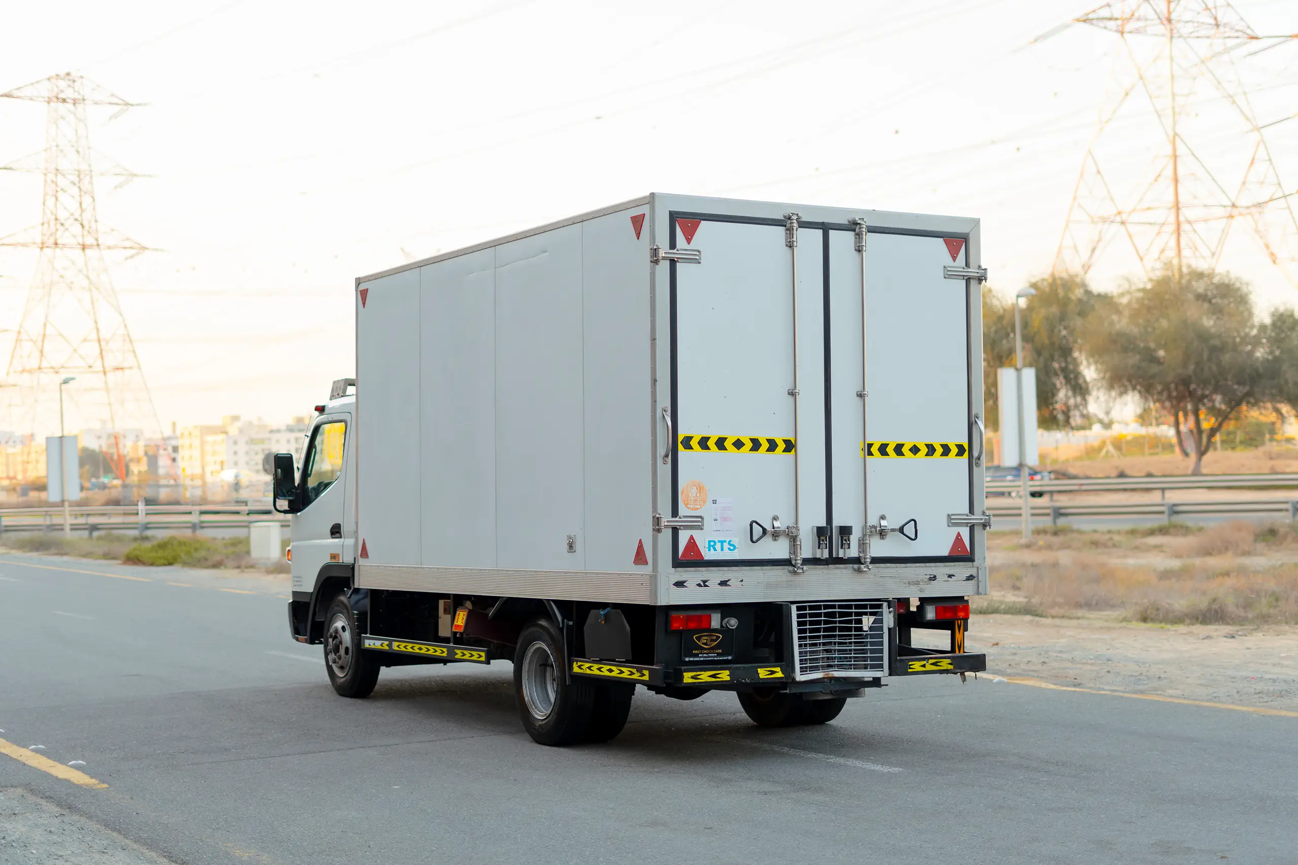 Used 2020 Mitsubishi Canter Chiller Box White – Left Back Diagonal (45°) View at First Choice Cars Sharjah