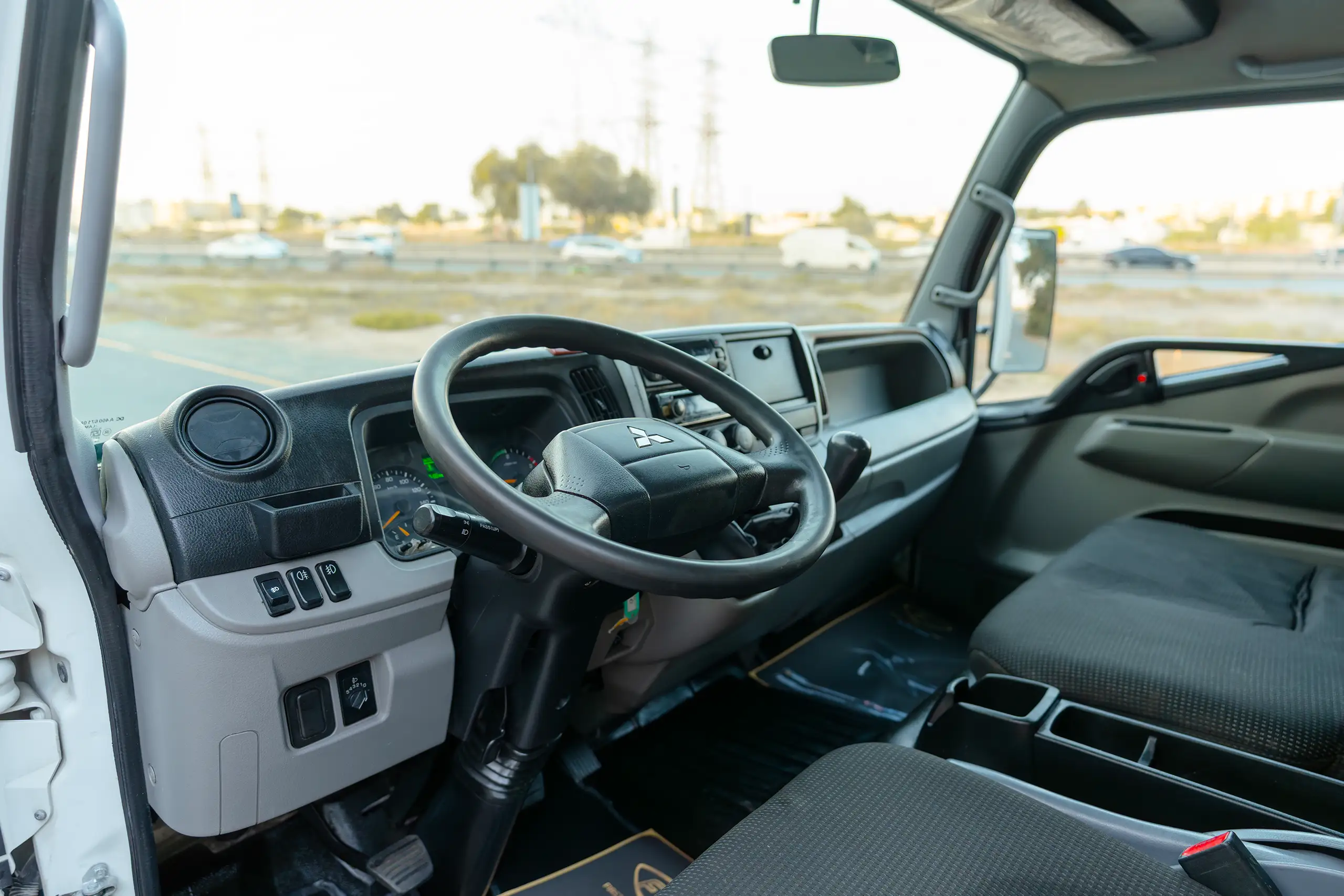Used 2020 Mitsubishi Canter Chiller Box White – Driver Side Dashboard & Steering View at First Choice Cars Sharjah