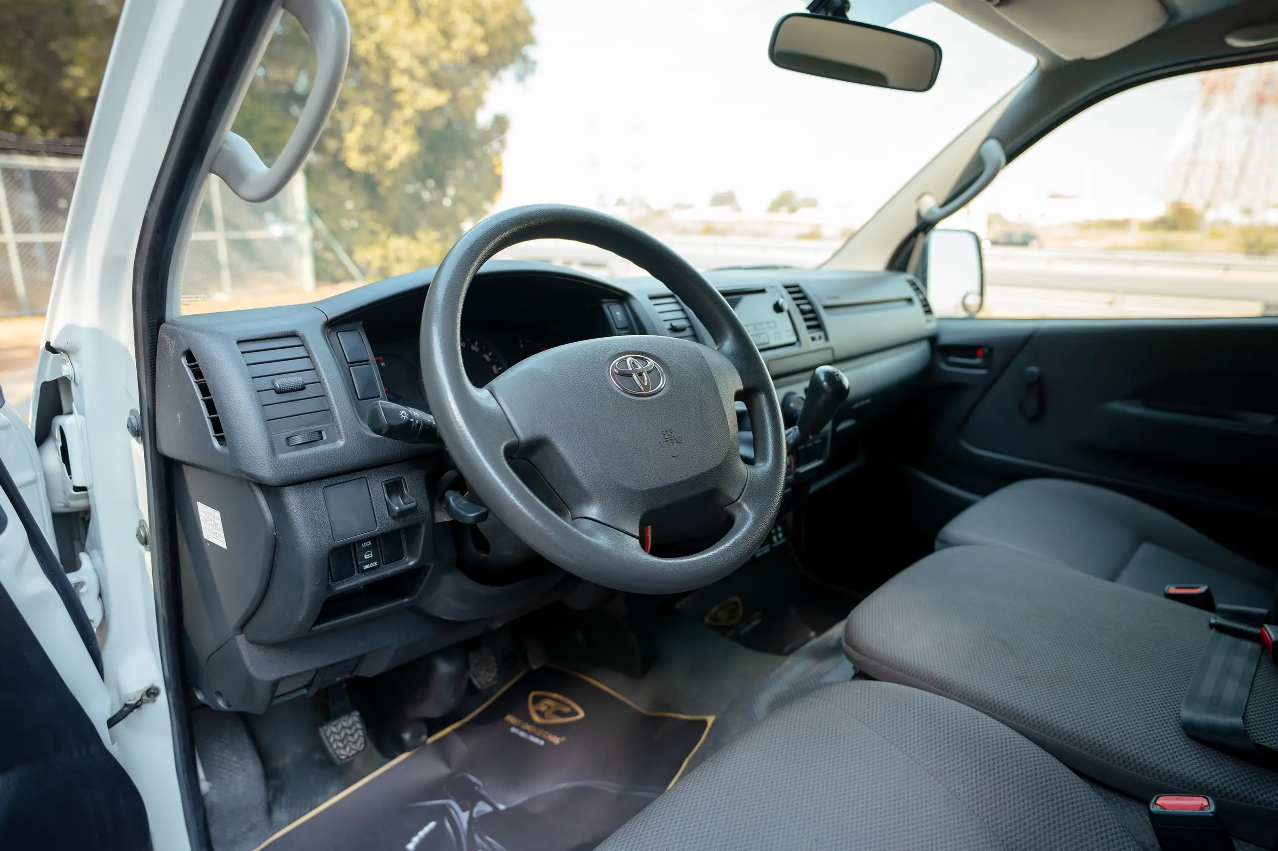 Used 2023 Toyota Hiace GL Standard Roof White – Driver Side Dashboard & Steering View at First Choice Cars Sharjah