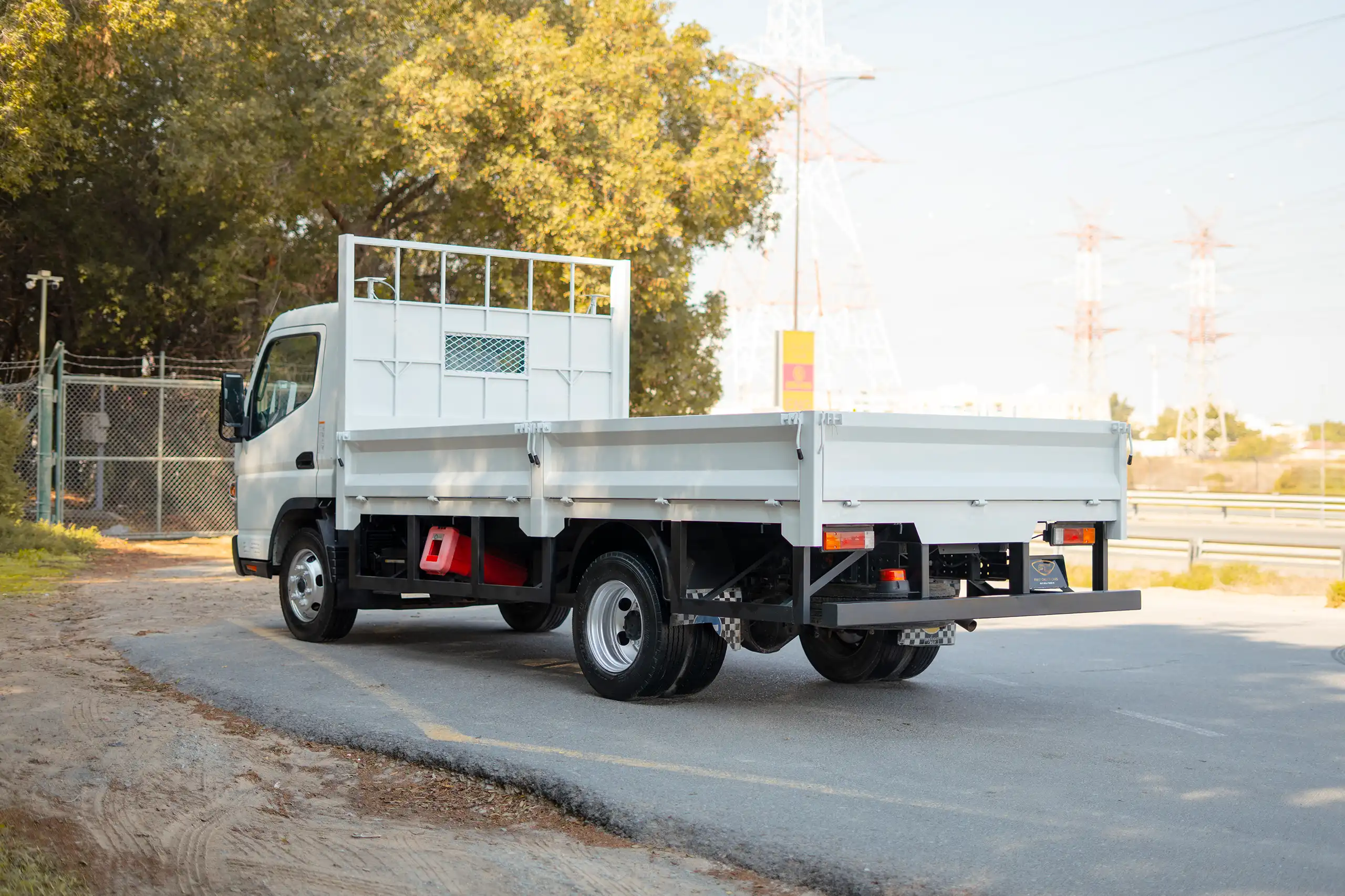 Used 2022 Mitsubishi Canter Cargo Body in White – Left Back Diagonal (45°) View for Sale at First Choice Cars Dubai Sharjah