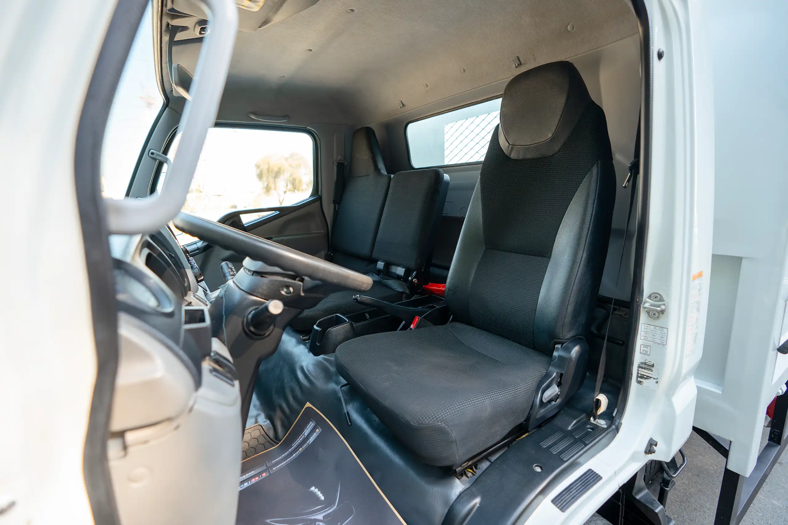 Used 2022 Mitsubishi Canter Cargo Body in White – Front Driver Side Cabin View for Sale at First Choice Cars Dubai Sharjah