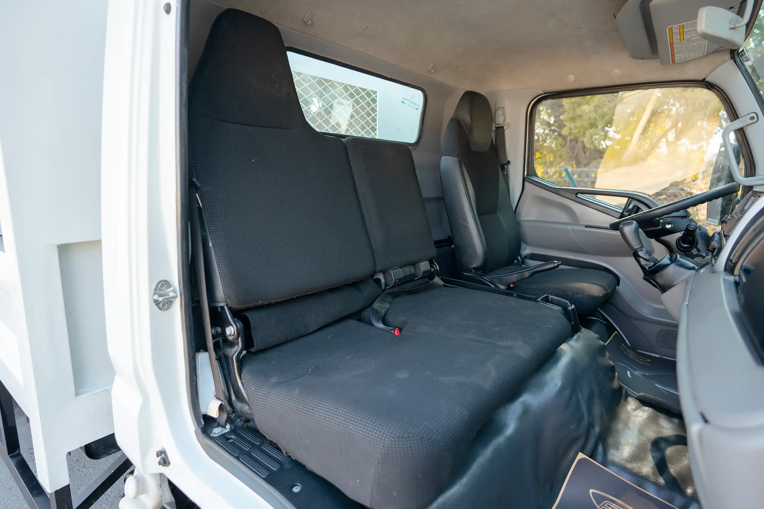 Used 2022 Mitsubishi Canter Cargo Body in White – Front Passenger Side Cabin View for Sale at First Choice Cars Dubai Sharjah