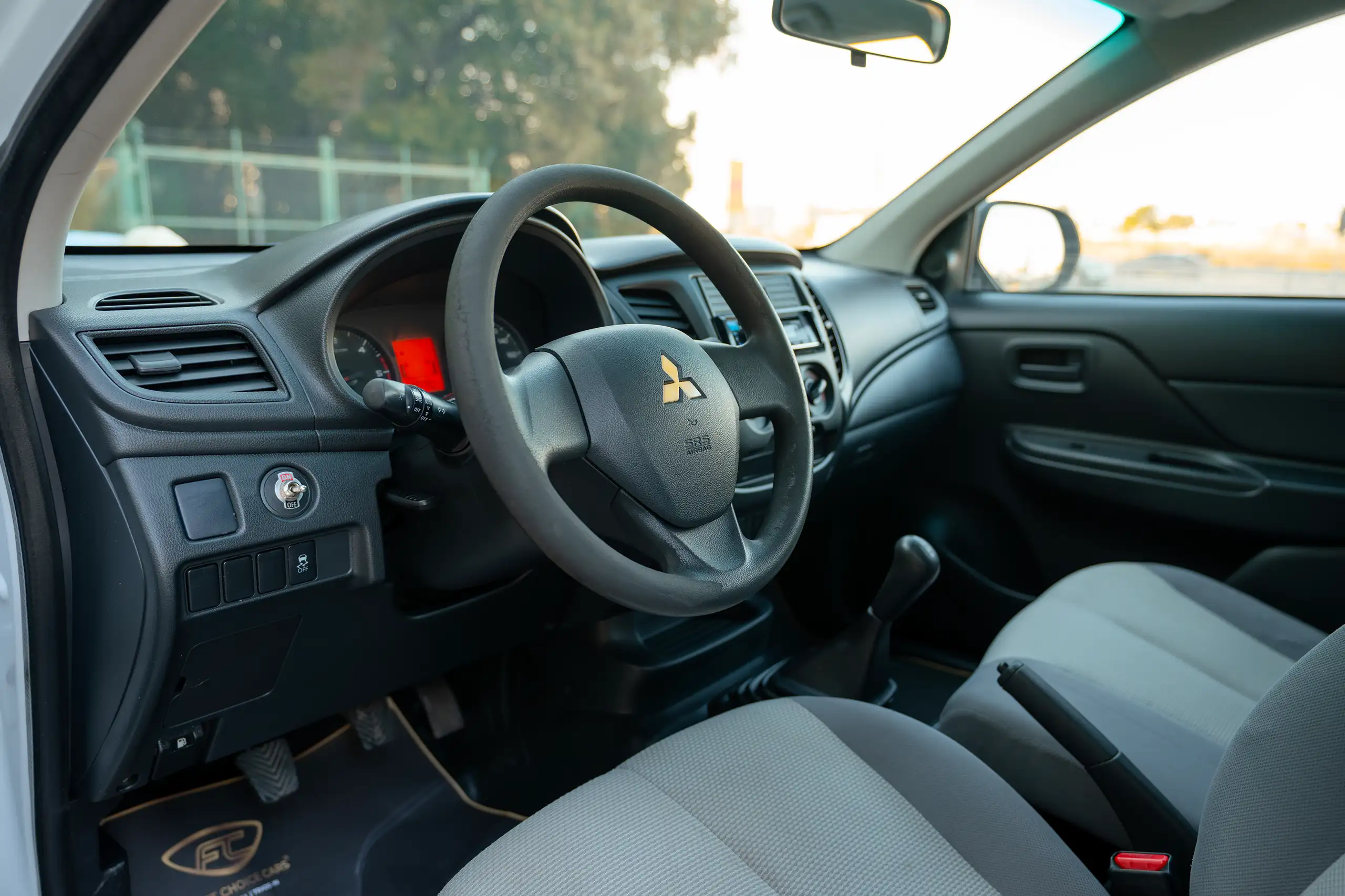 Used 2020 Mitsubishi L200 GL Double Cabin White – Driver Side Dashboard & Steering View at First Choice Cars Sharjah