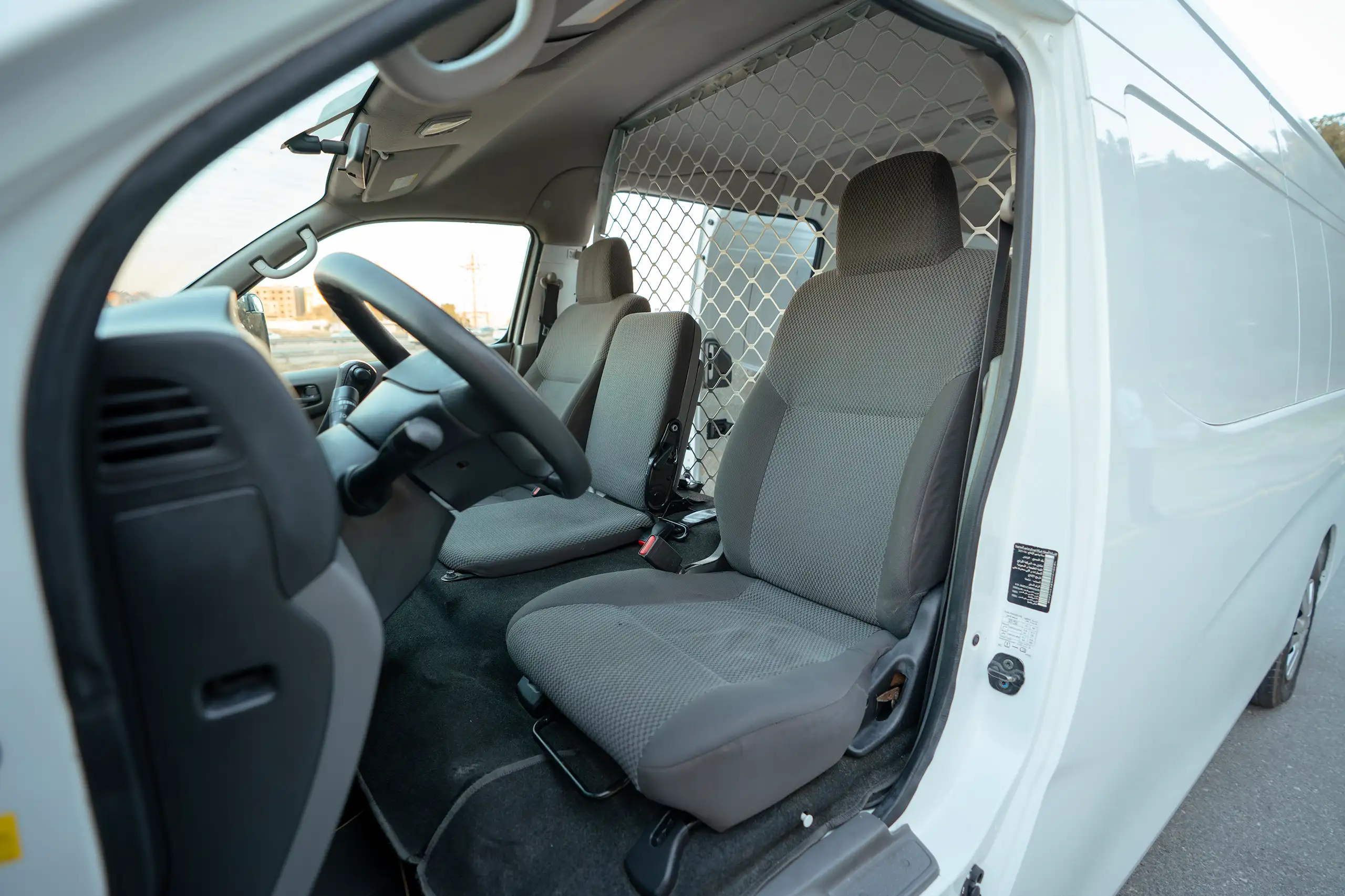 Used 2022 Nissan Urvan High Roof White – Front Driver Side Cabin View at First Choice Cars Sharjah