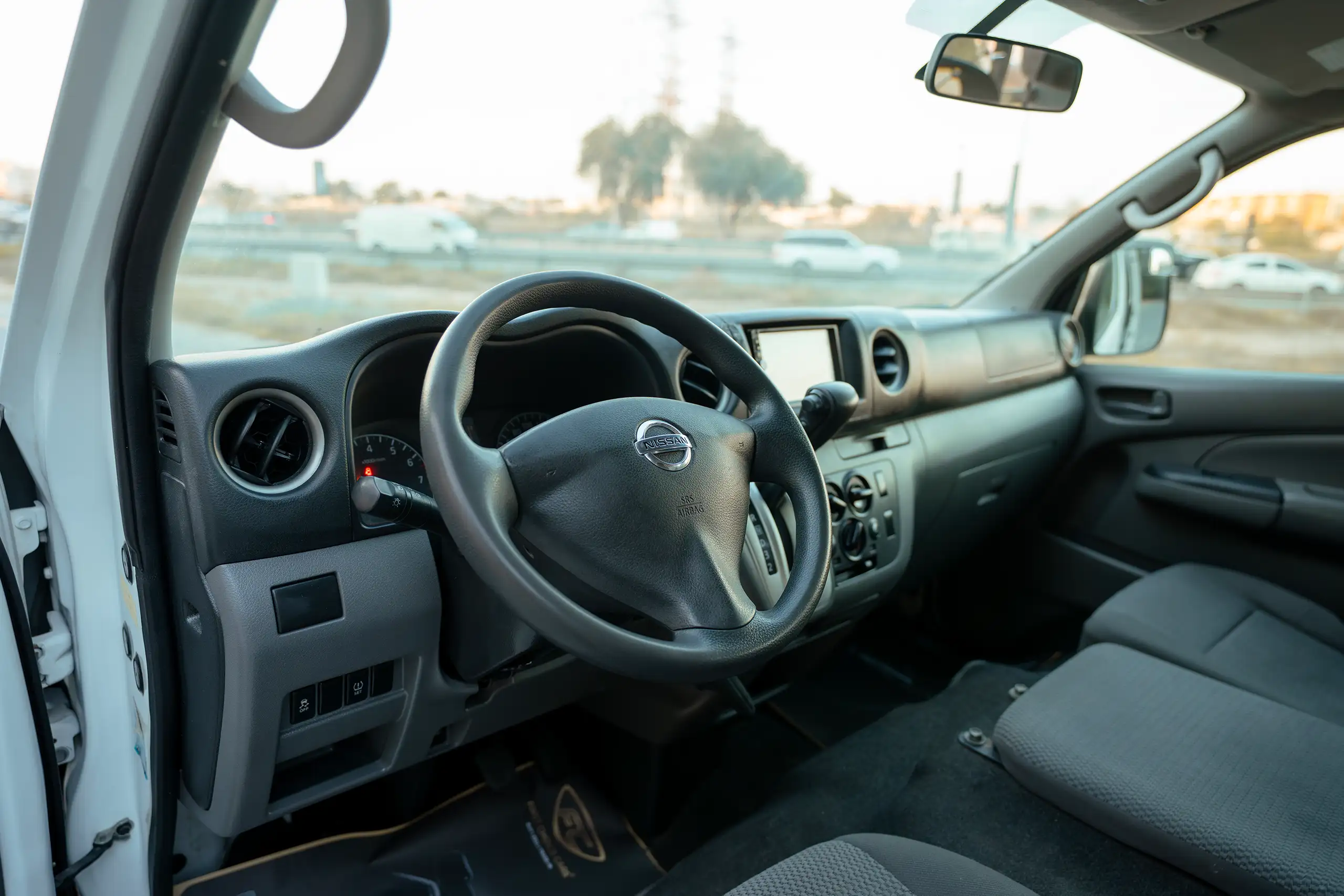 Used 2022 Nissan Urvan High Roof White – Driver Side Dashboard & Steering View at First Choice Cars Sharjah