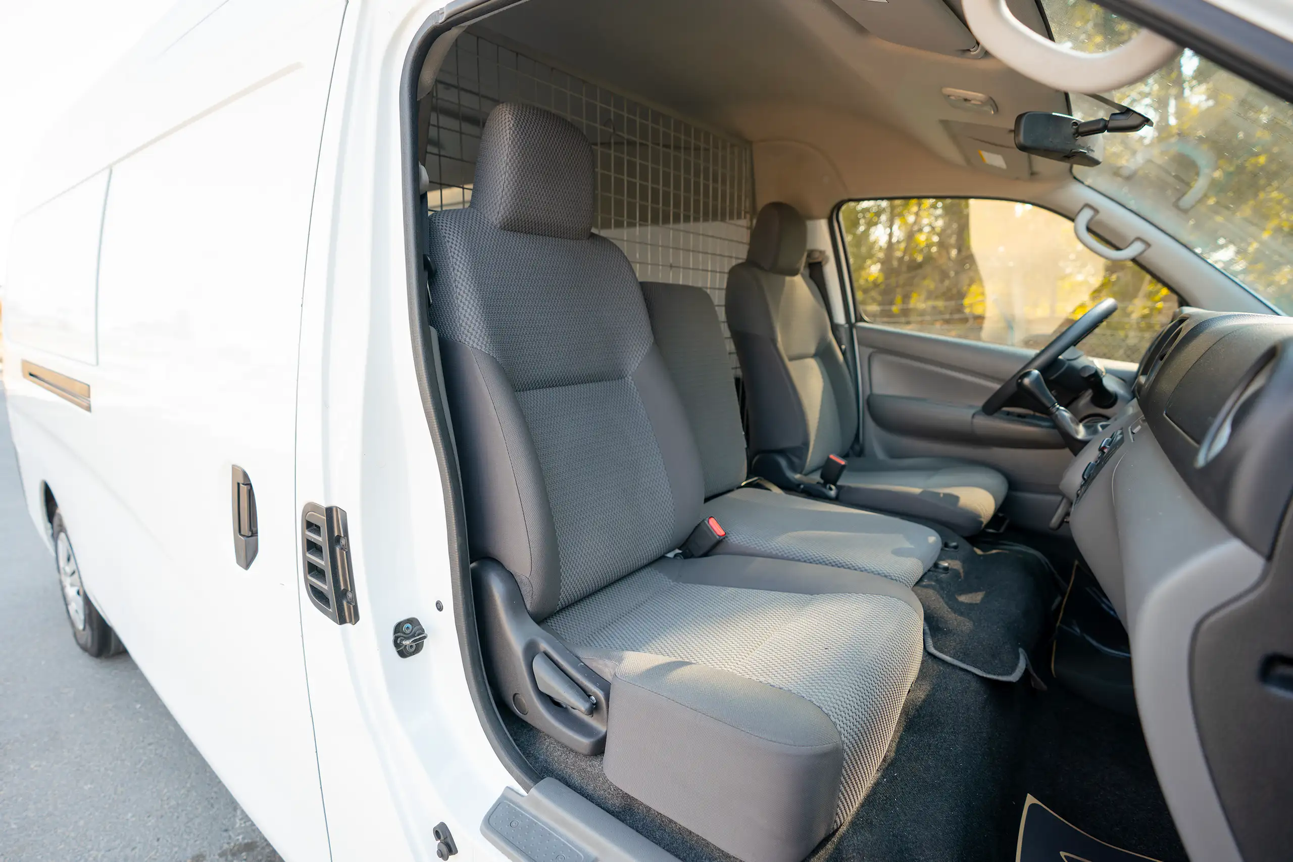 Used 2022 Nissan Urvan High Roof White – Front Passenger Side Cabin View at First Choice Cars Sharjah