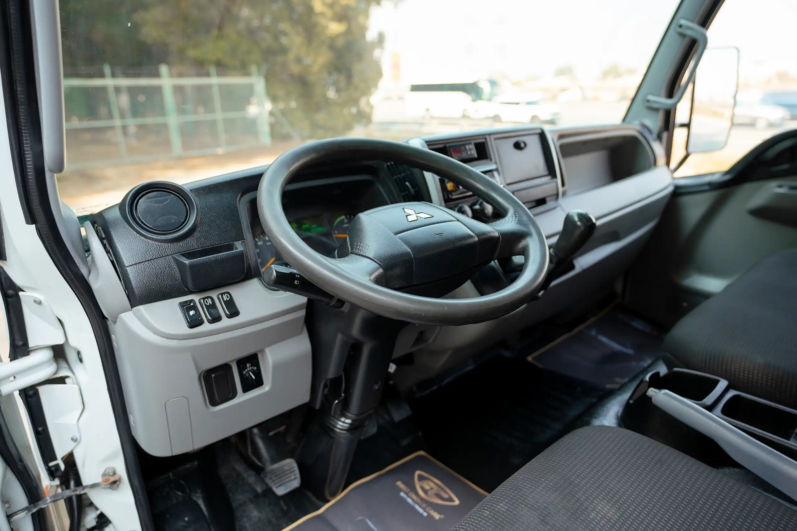 Used 2020 Mitsubishi Canter Chiller Box White – Driver Side Dashboard & Steering View at First Choice Cars Sharjah