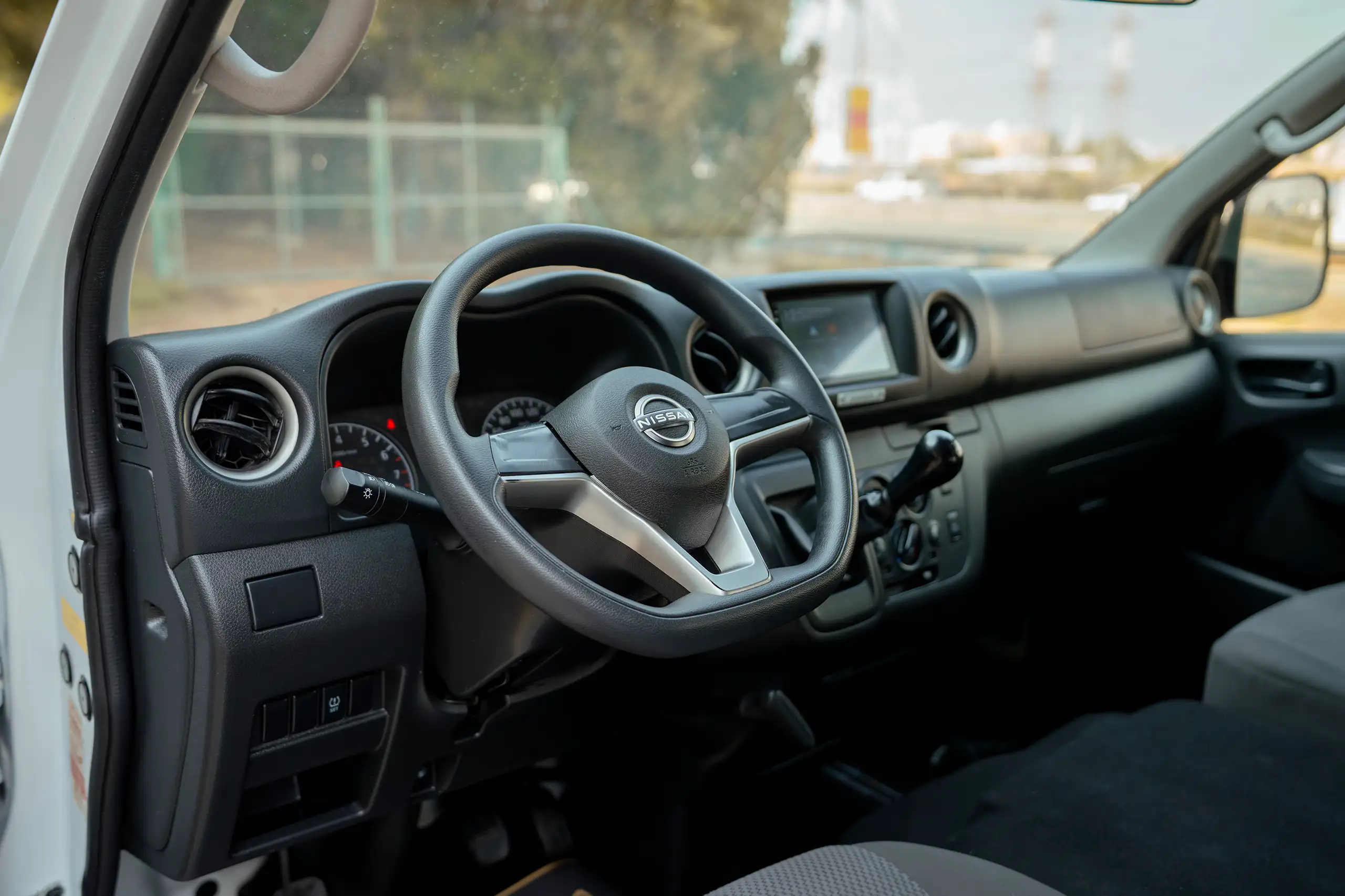 Used 2024 Nissan Urvan High Roof White – Driver Side Dashboard & Steering View at First Choice Cars Sharjah