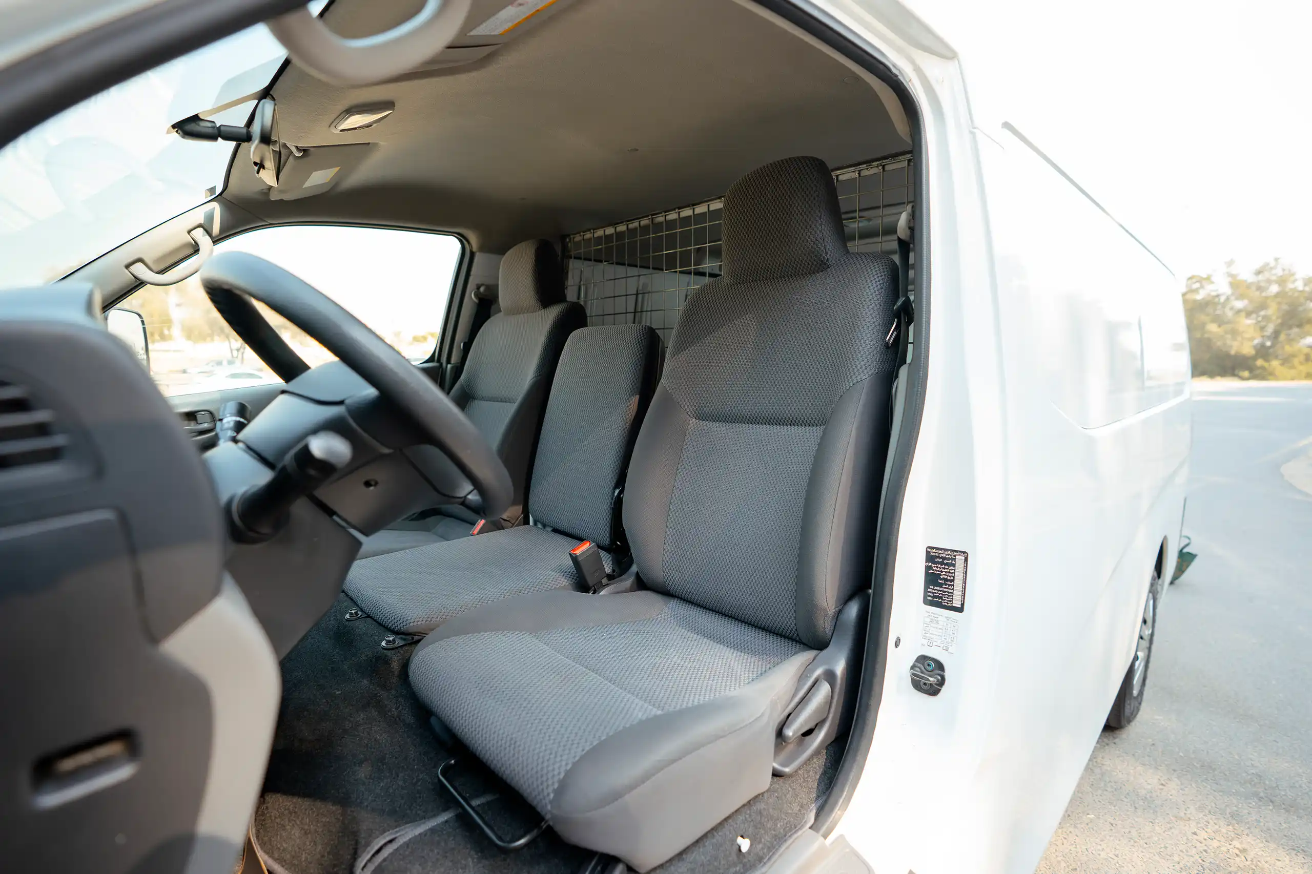 Used 2022 Nissan Urvan Standard Roof White – Front Driver Side Cabin View at First Choice Cars Sharjah