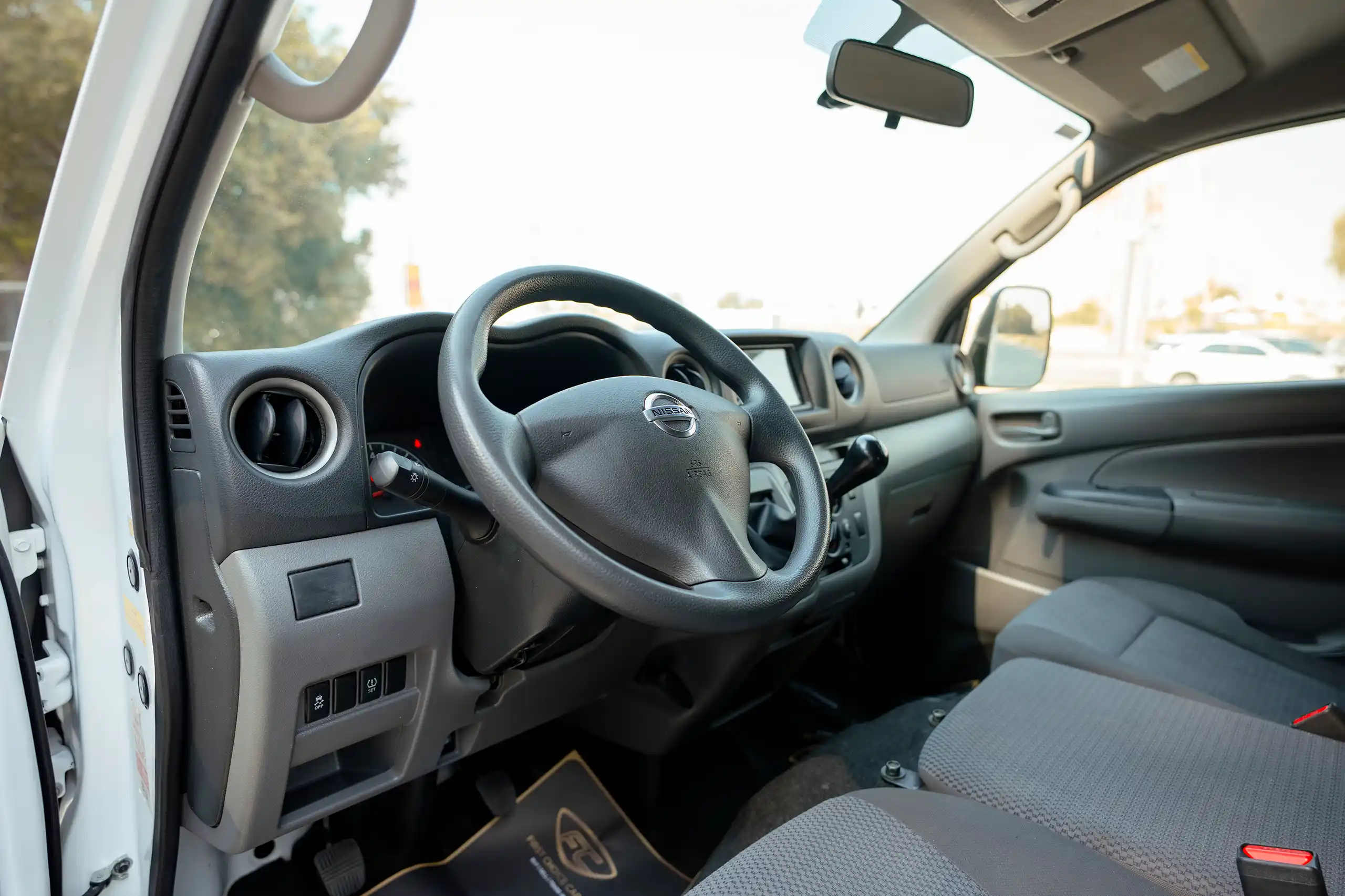 Used 2022 Nissan Urvan Standard Roof White – Driver Side Dashboard & Steering View at First Choice Cars Sharjah