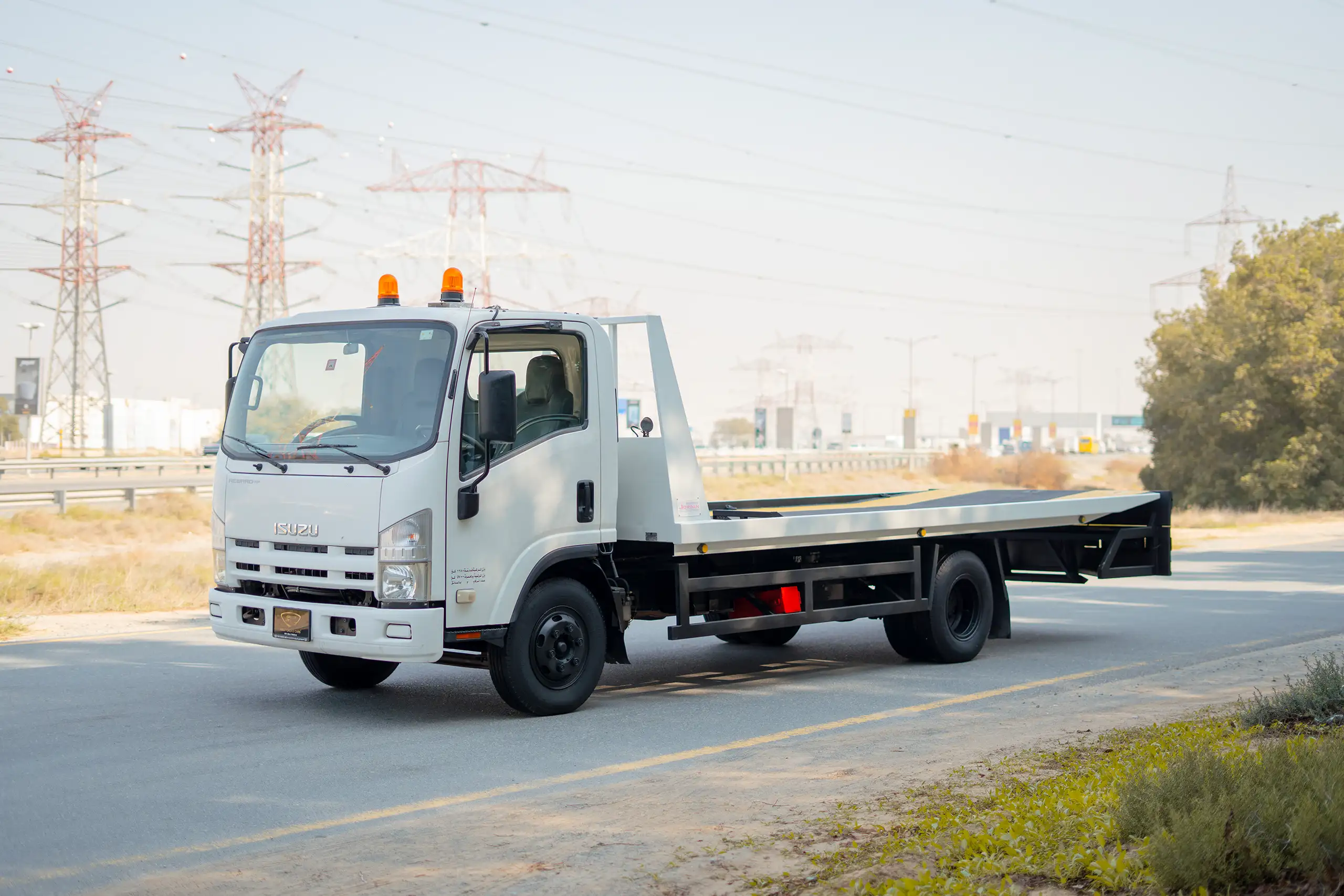 Used 2017 Isuzu NPR Recovery in White – Left Front Diagonal (45°) View for Sale at First Choice Cars Dubai Sharjah