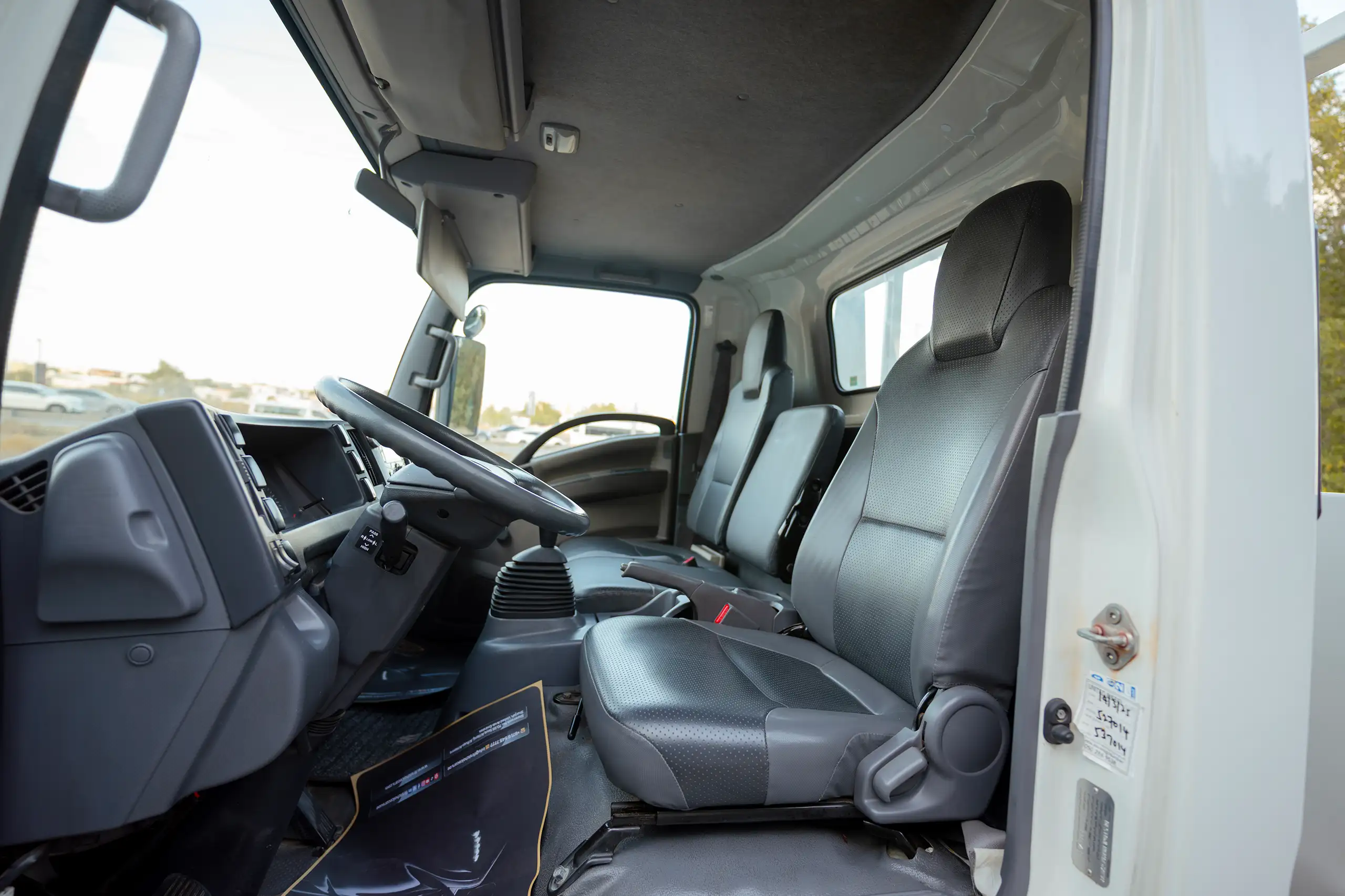 Used 2017 Isuzu NPR Recovery in White – Front Driver Side Cabin View for Sale at First Choice Cars Dubai Sharjah