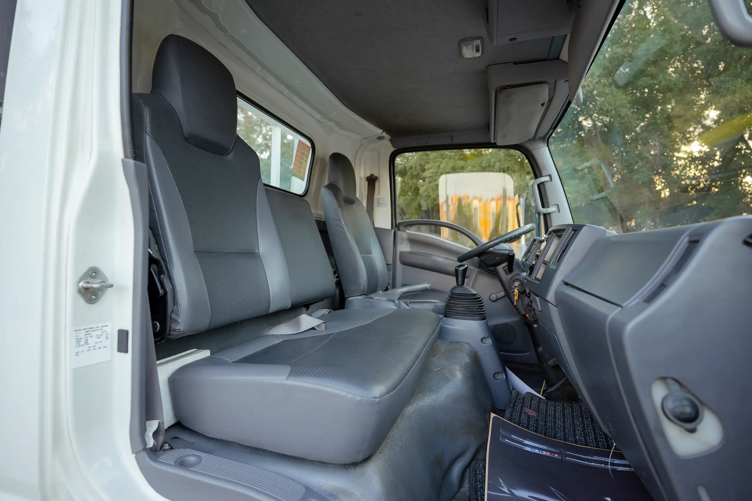 Used 2017 Isuzu NPR Recovery in White – Front Passenger Side Cabin View for Sale at First Choice Cars Dubai Sharjah