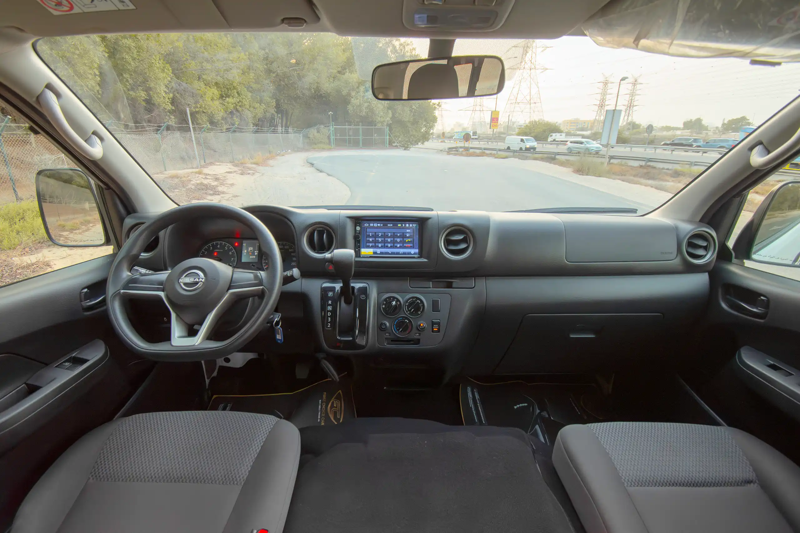 Used 2023 Nissan Urvan High Roof White – Front Cabin / Dashboard Full View at First Choice Cars Sharjah