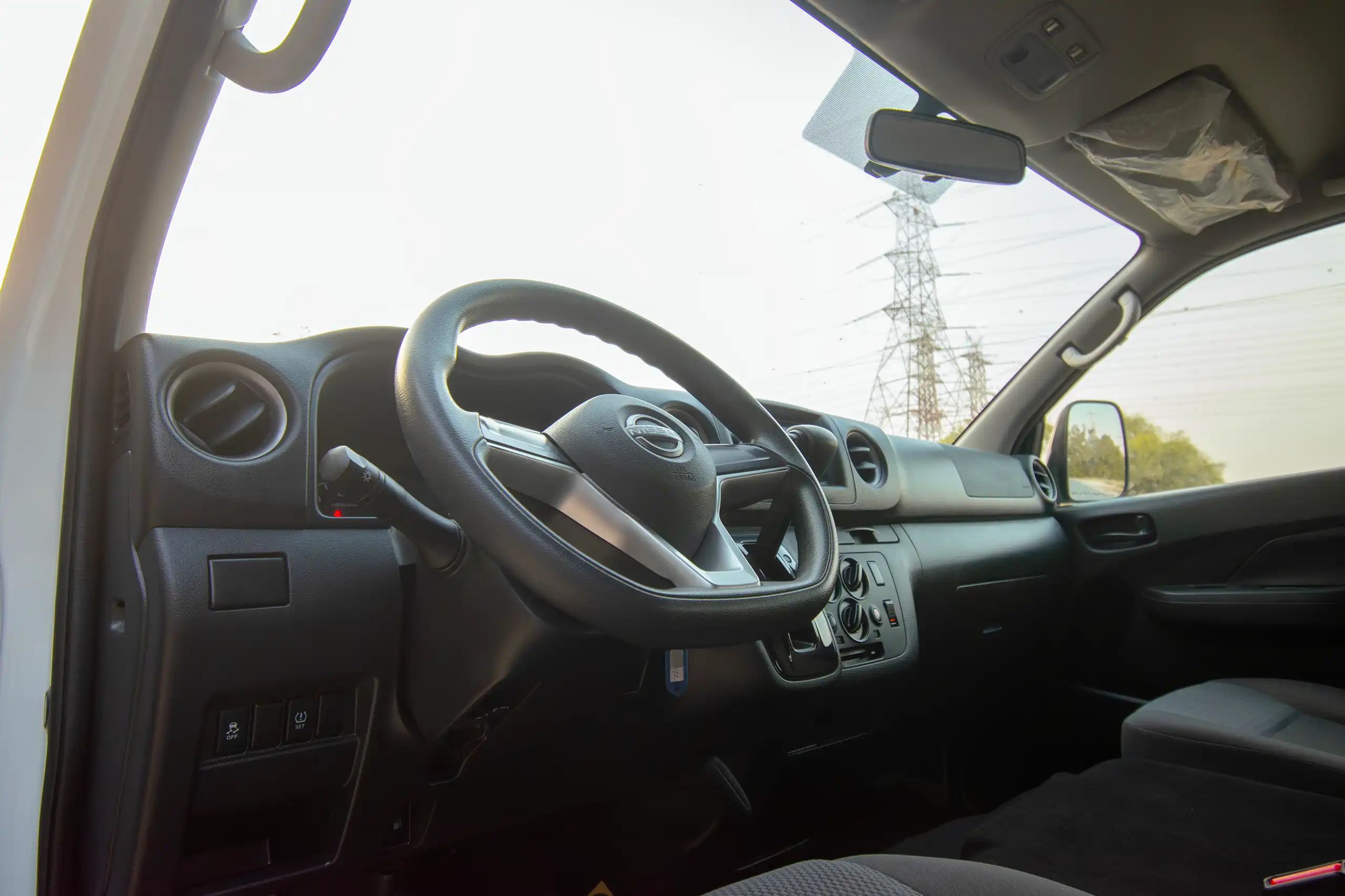 Used 2023 Nissan Urvan High Roof White – Driver Side Dashboard & Steering View at First Choice Cars Sharjah