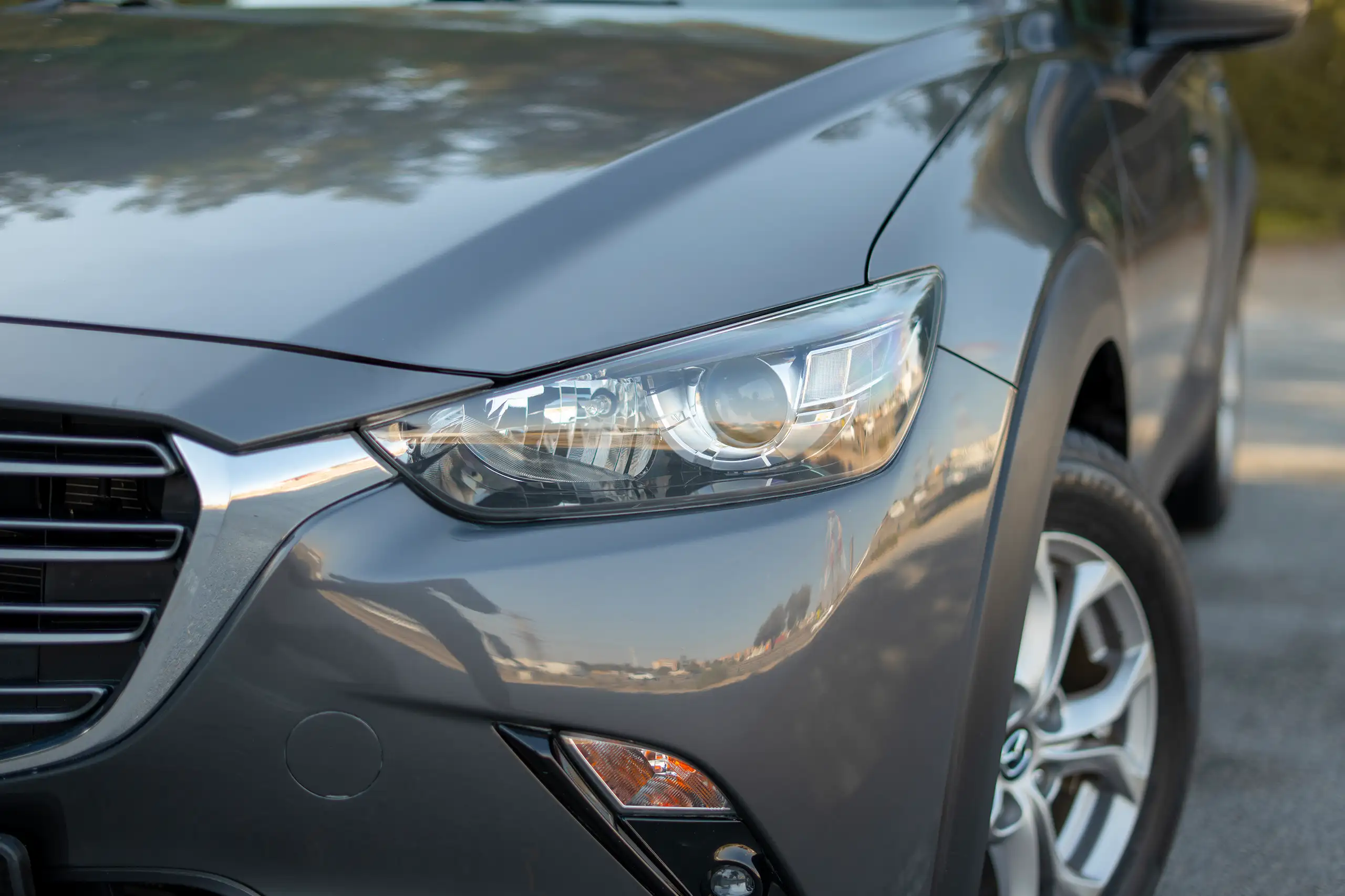Used 2022 Mazda CX-3 GS Grey – Headlight Close-up at First Choice Cars Sharjah