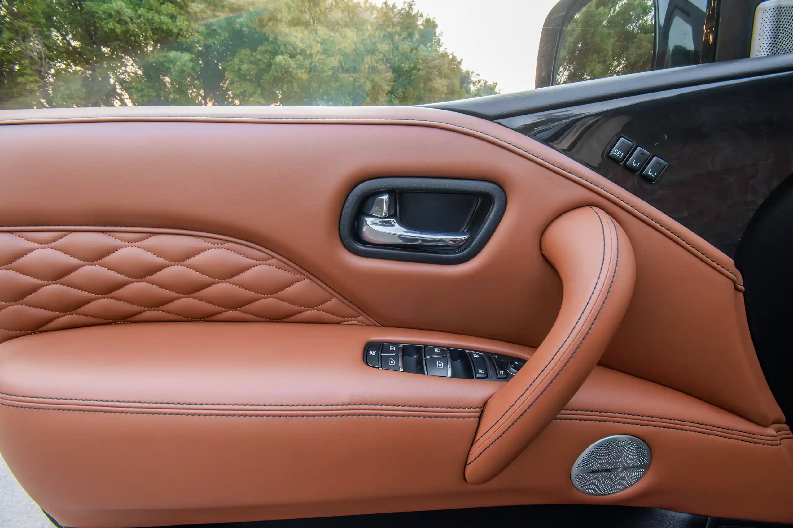 Used 2023 Infiniti QX80 Luxury Gold – Driver Door Panel Full View at First Choice Cars Sharjah