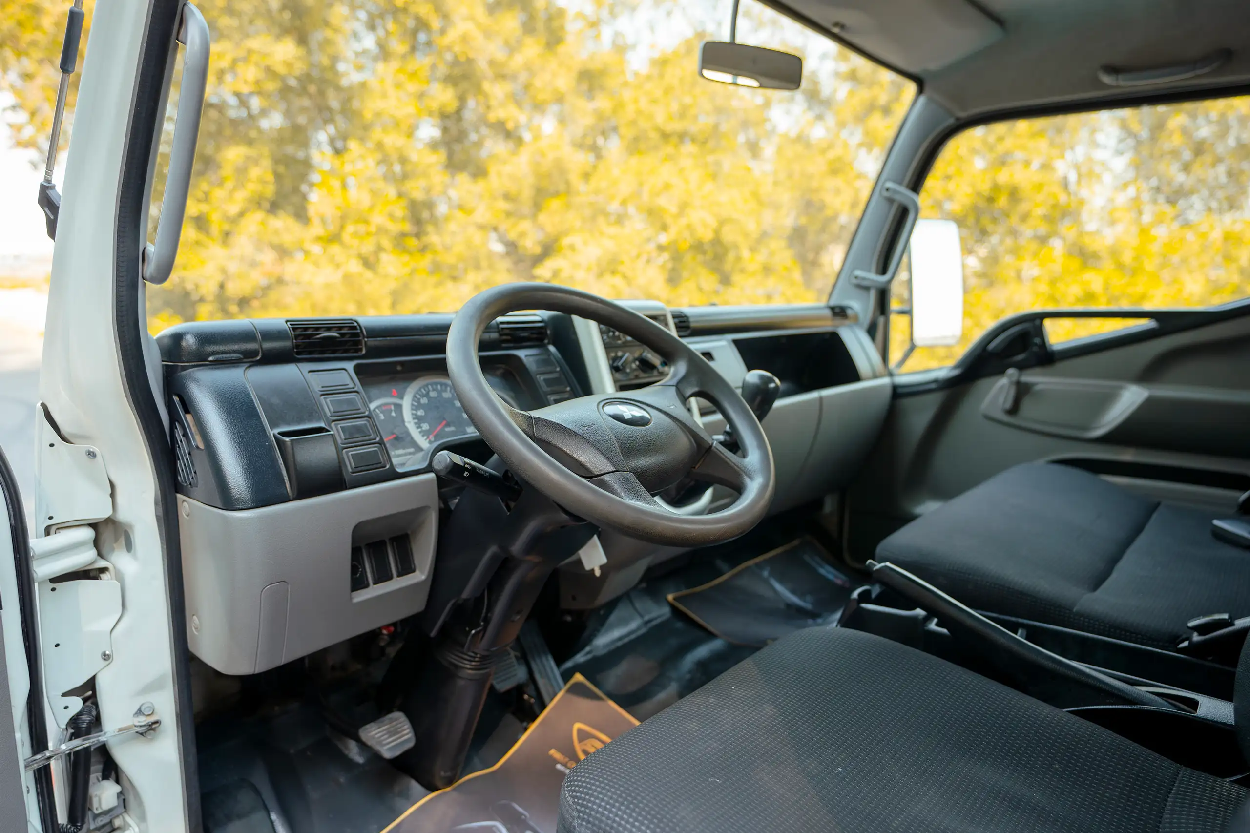 Used 2017 Mitsubishi Canter Cargo Body White – Driver Side Dashboard & Steering View at First Choice Cars Sharjah