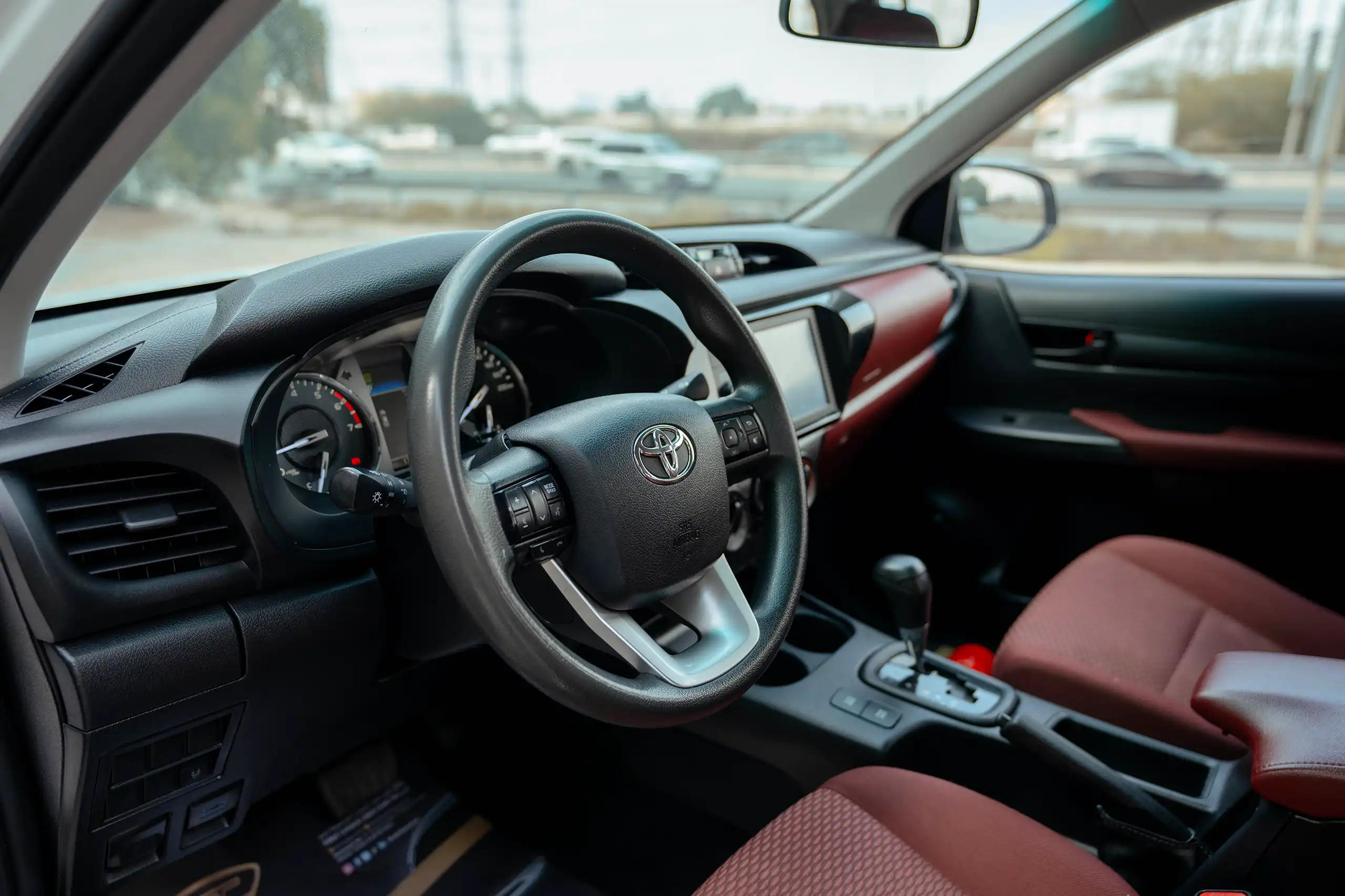 Used 2022 Toyota Hilux GLX Double Cabin White – Driver Side Dashboard & Steering View at First Choice Cars Sharjah