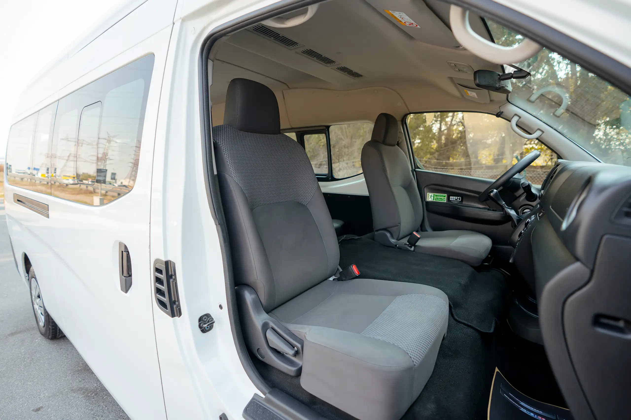 Used 2024 Nissan Urvan High Roof White – Front Passenger Side Cabin View at First Choice Cars Sharjah