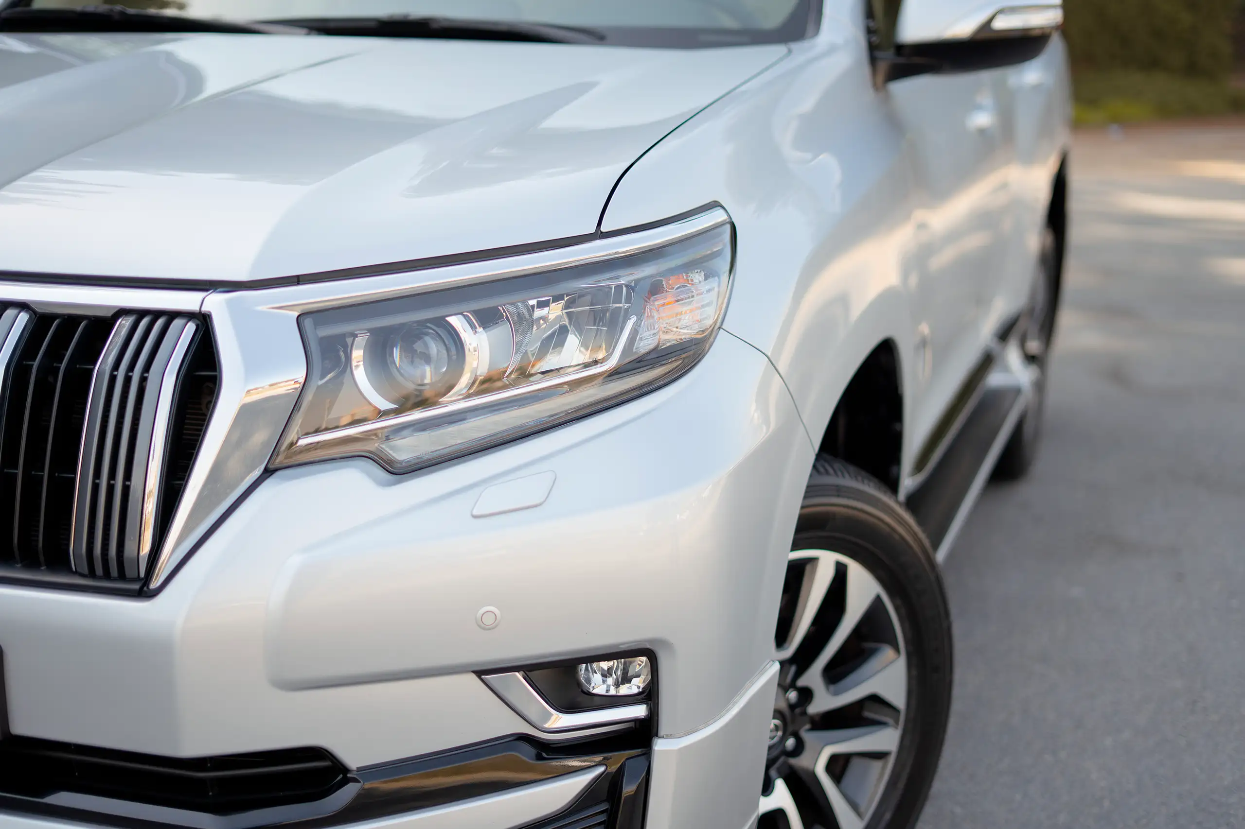 Used 2023 Toyota Prado VXR Silver – Headlight Close-up at First Choice Cars Sharjah
