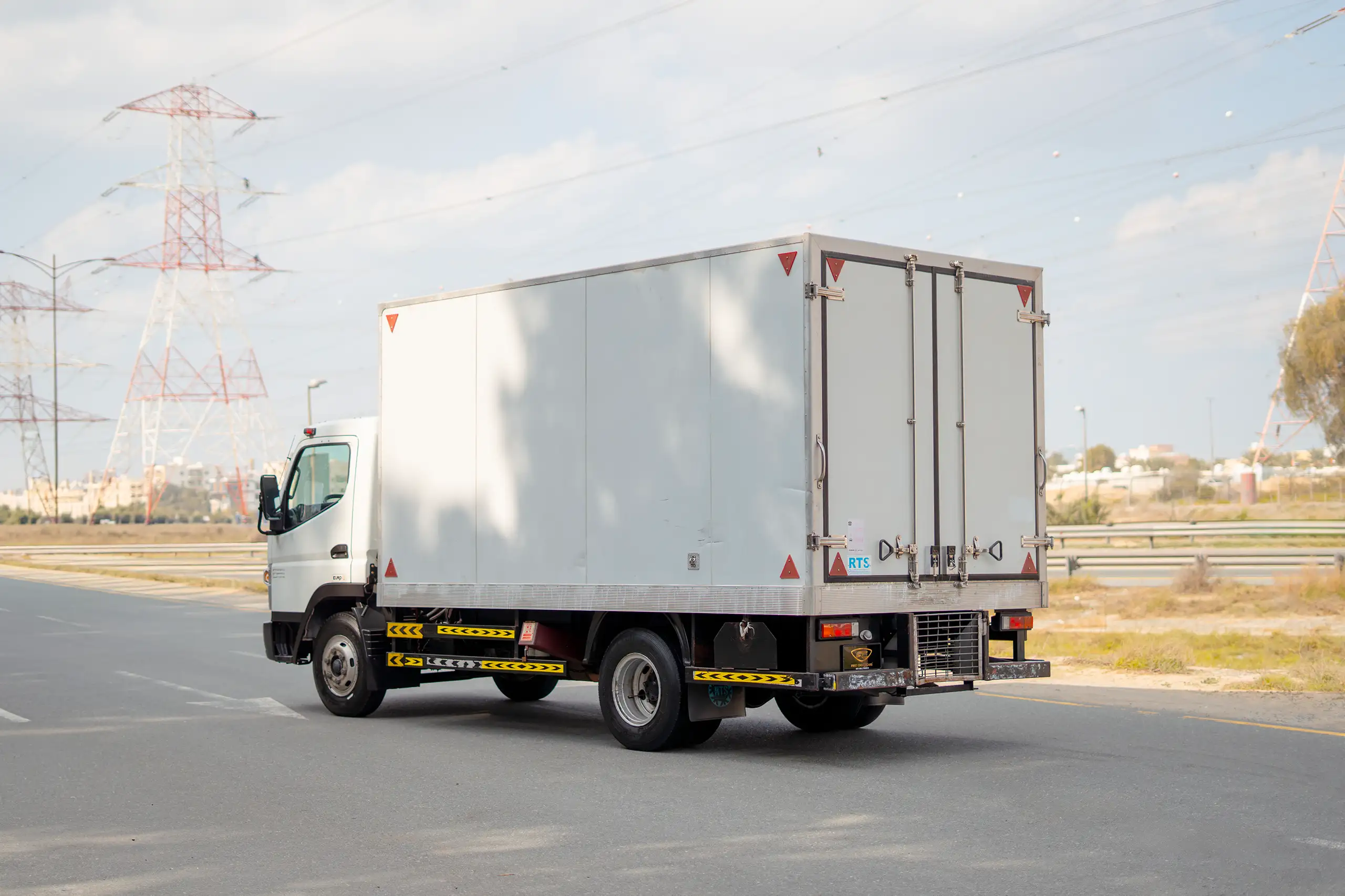 Used 2020 Mitsubishi Canter Chiller Box White – Left Back Diagonal (45°) View at First Choice Cars Sharjah