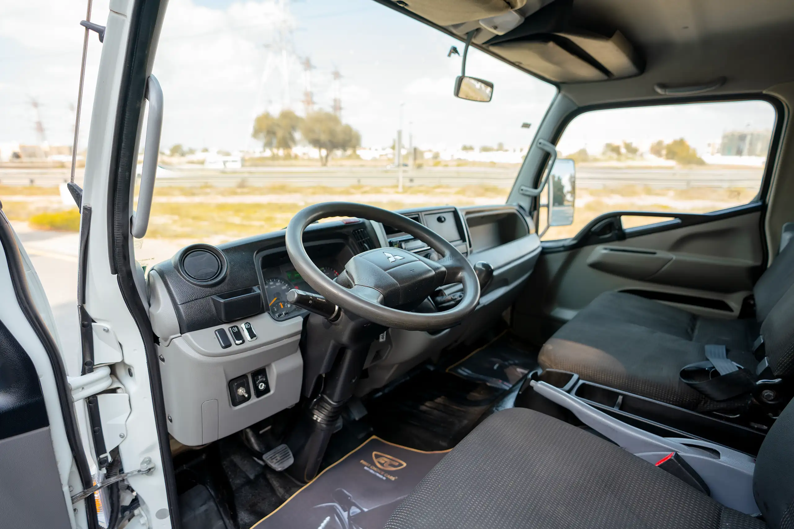 Used 2020 Mitsubishi Canter Chiller Box White – Driver Side Dashboard & Steering View at First Choice Cars Sharjah