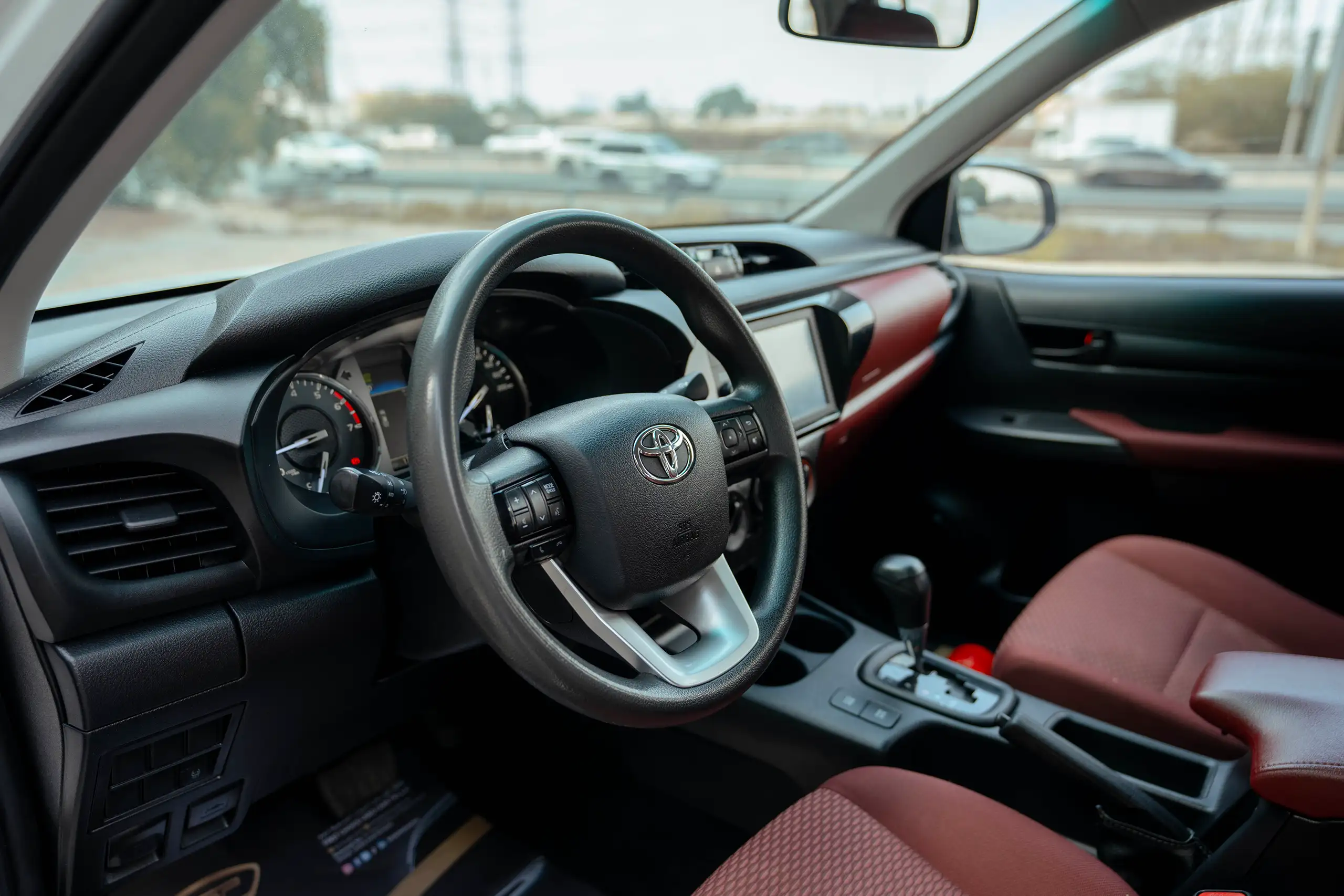 Used 2021 Toyota Hilux GLX Double Cabin White – Driver Side Dashboard & Steering View at First Choice Cars Sharjah