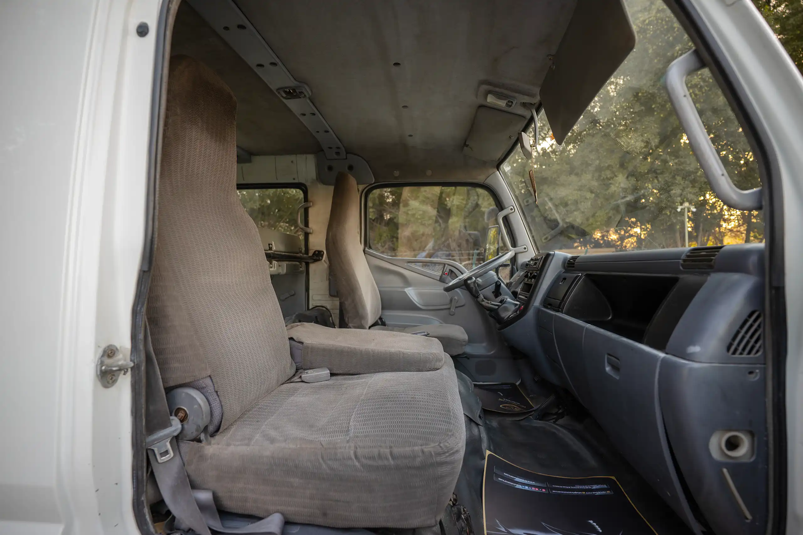 Used 2006 Mitsubishi Canter Double Cabin Cargo Body White – Front Passenger Side Cabin View at First Choice Cars Sharjah