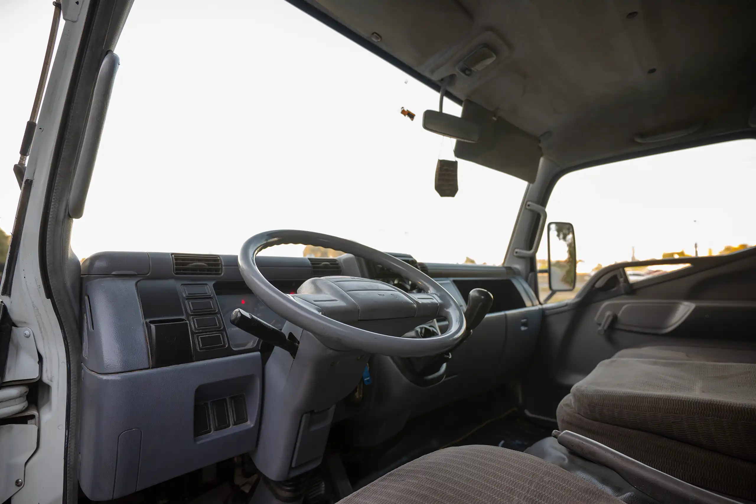 Used 2006 Mitsubishi Canter Double Cabin Cargo Body White – Driver Side Dashboard & Steering View at First Choice Cars Sharjah