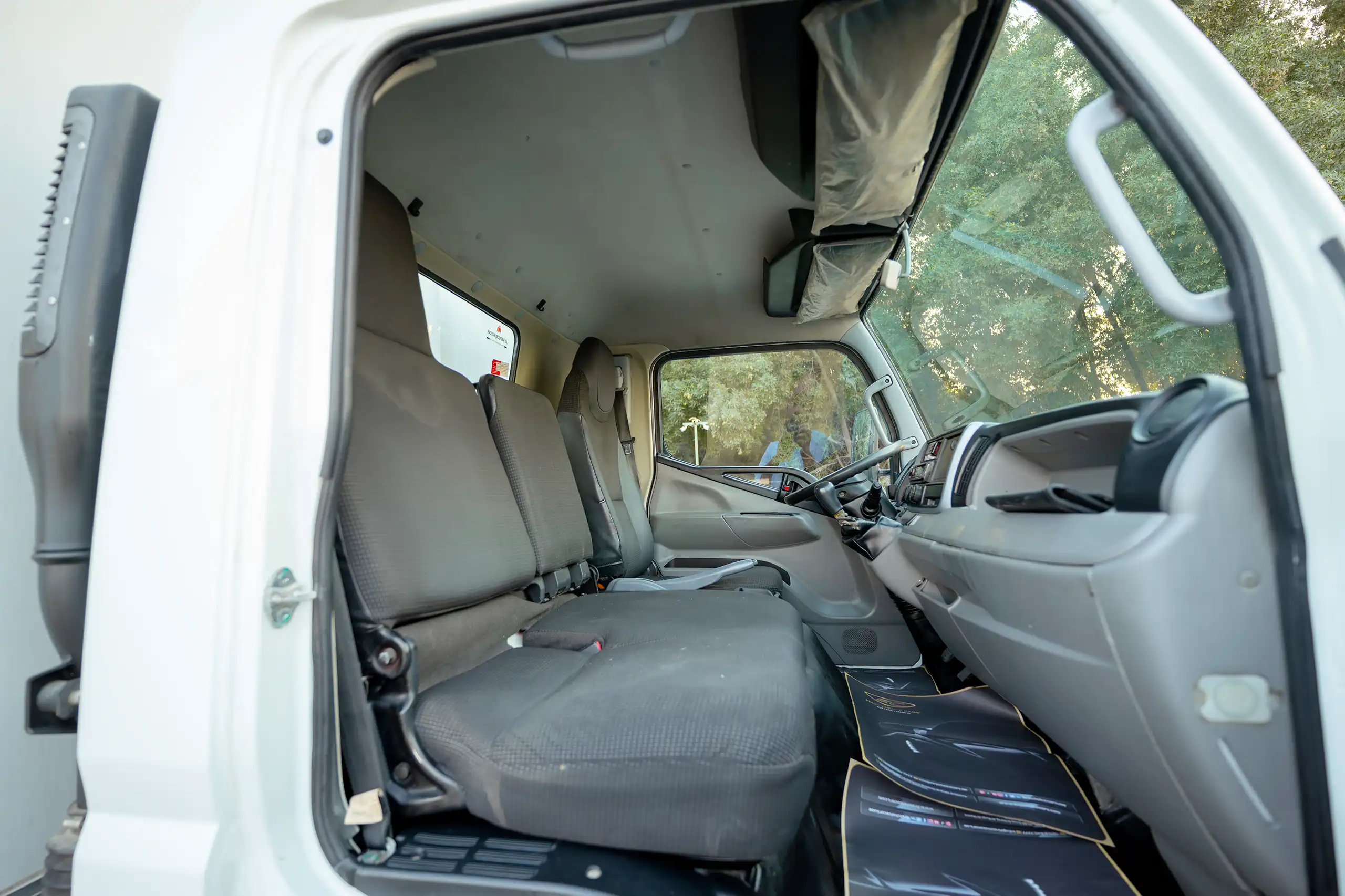 Used 2020 Mitsubishi Canter Chiller Box White – Front Passenger Side Cabin View at First Choice Cars Sharjah
