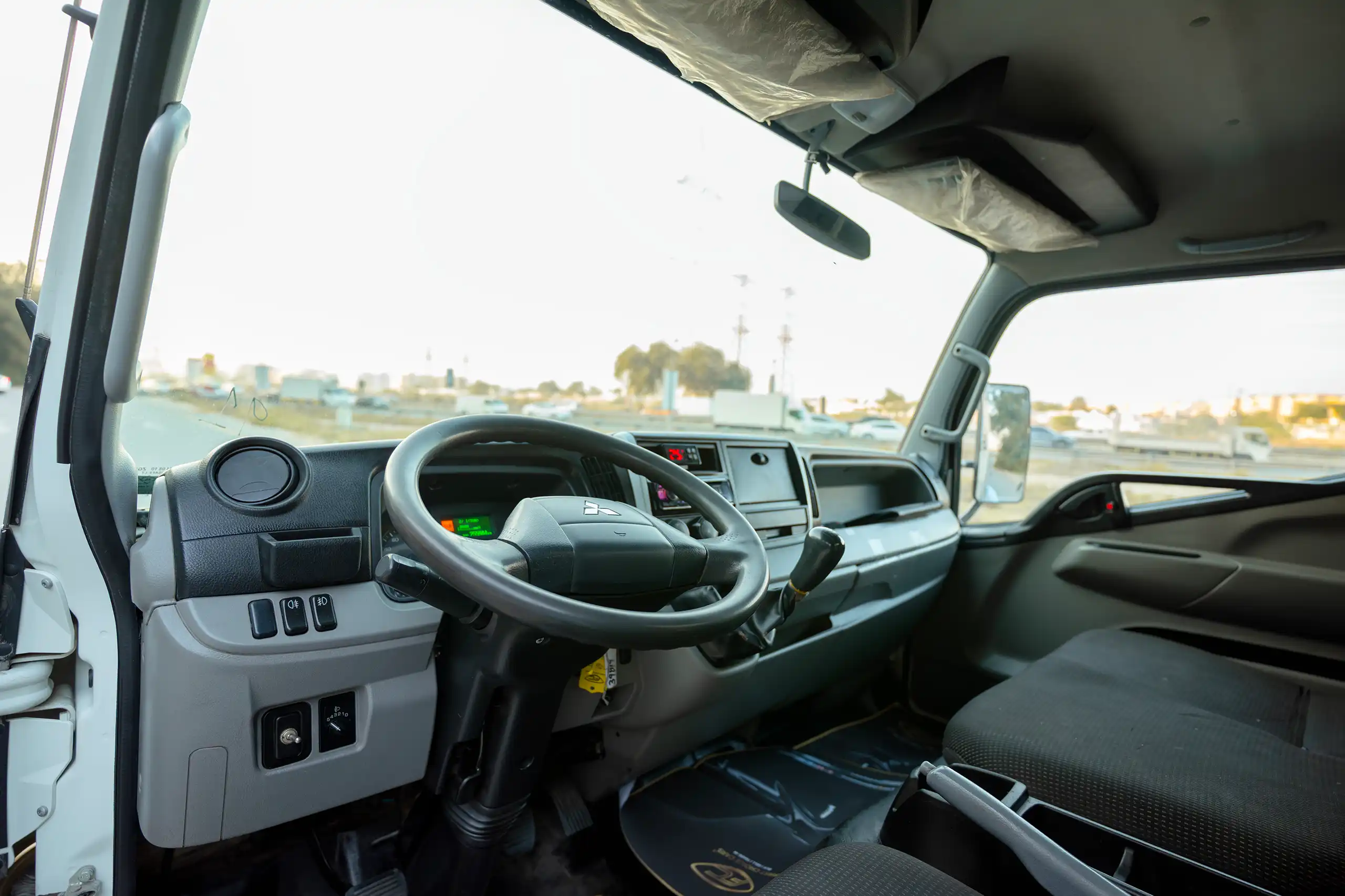 Used 2020 Mitsubishi Canter Chiller Box White – Driver Side Dashboard & Steering View at First Choice Cars Sharjah