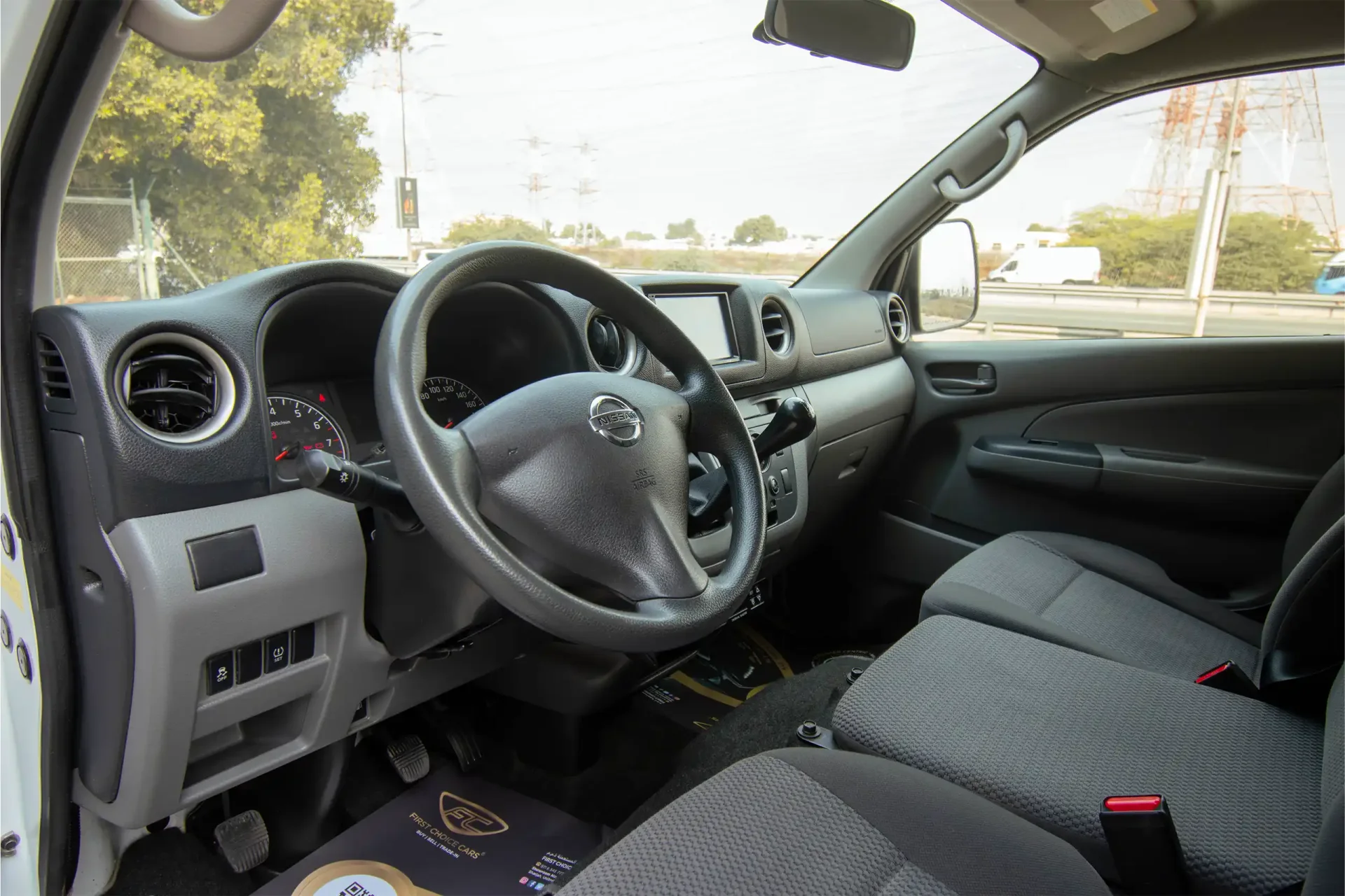 Used 2021 Nissan Urvan Standard Roof in White – Driver Side Dashboard & Steering View for Sale at First Choice Cars Dubai Sharjah