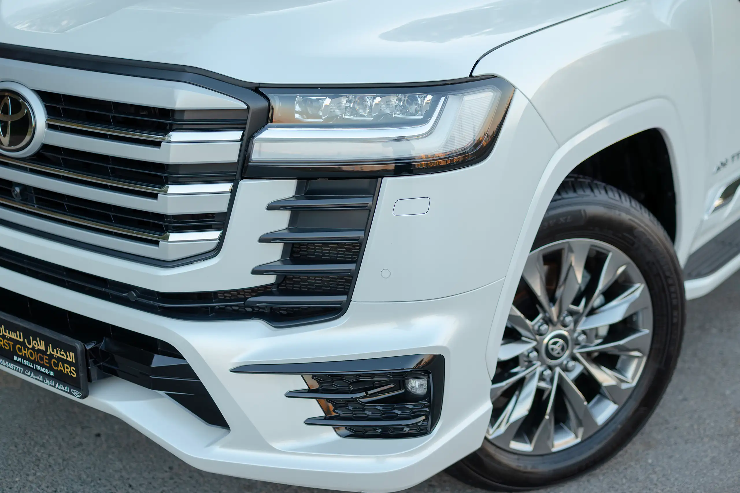 Used 2025 Toyota Land Cruiser VXR White – Headlight Close-up at First Choice Cars Sharjah